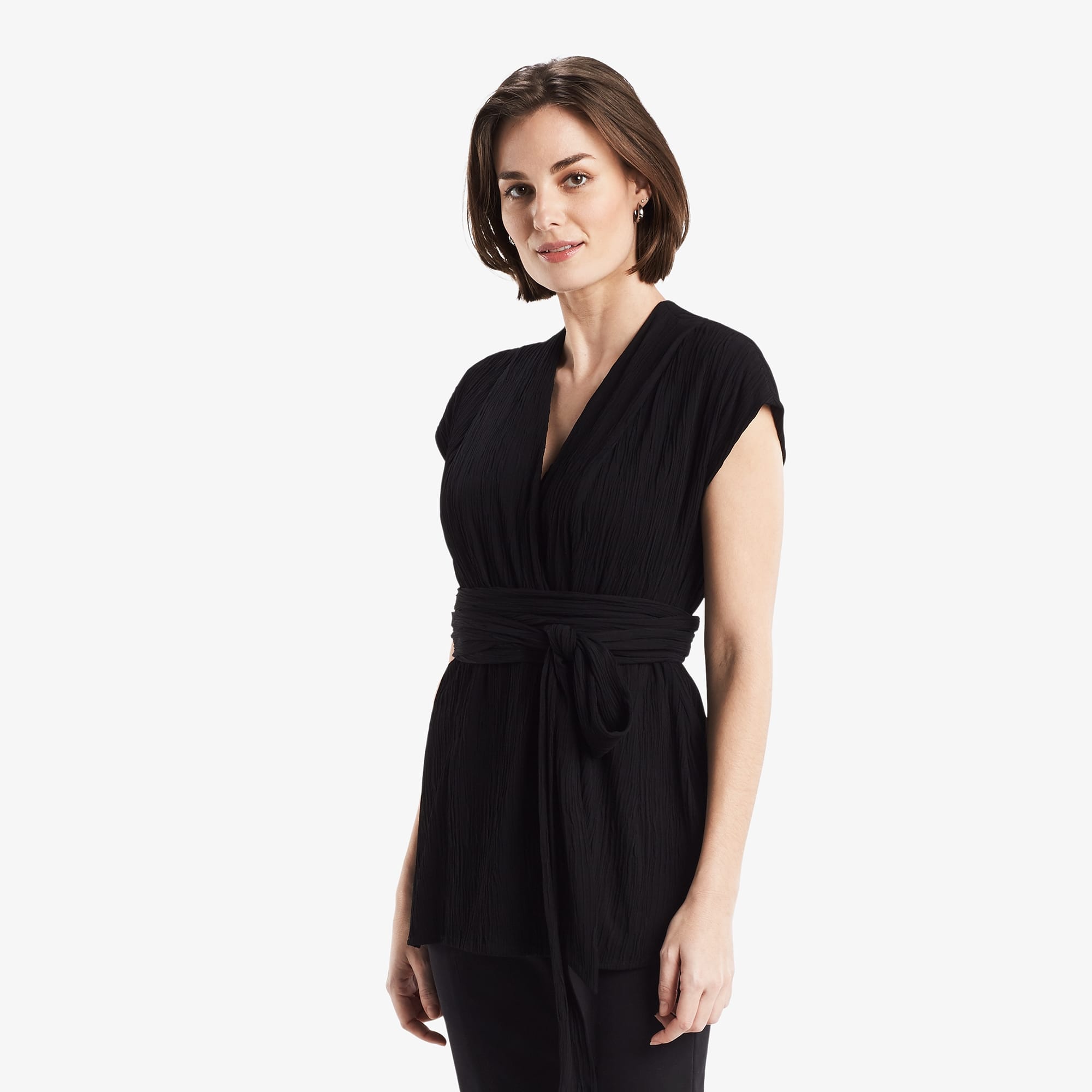 Side image of a woman standing wearing the Valerie Top in black