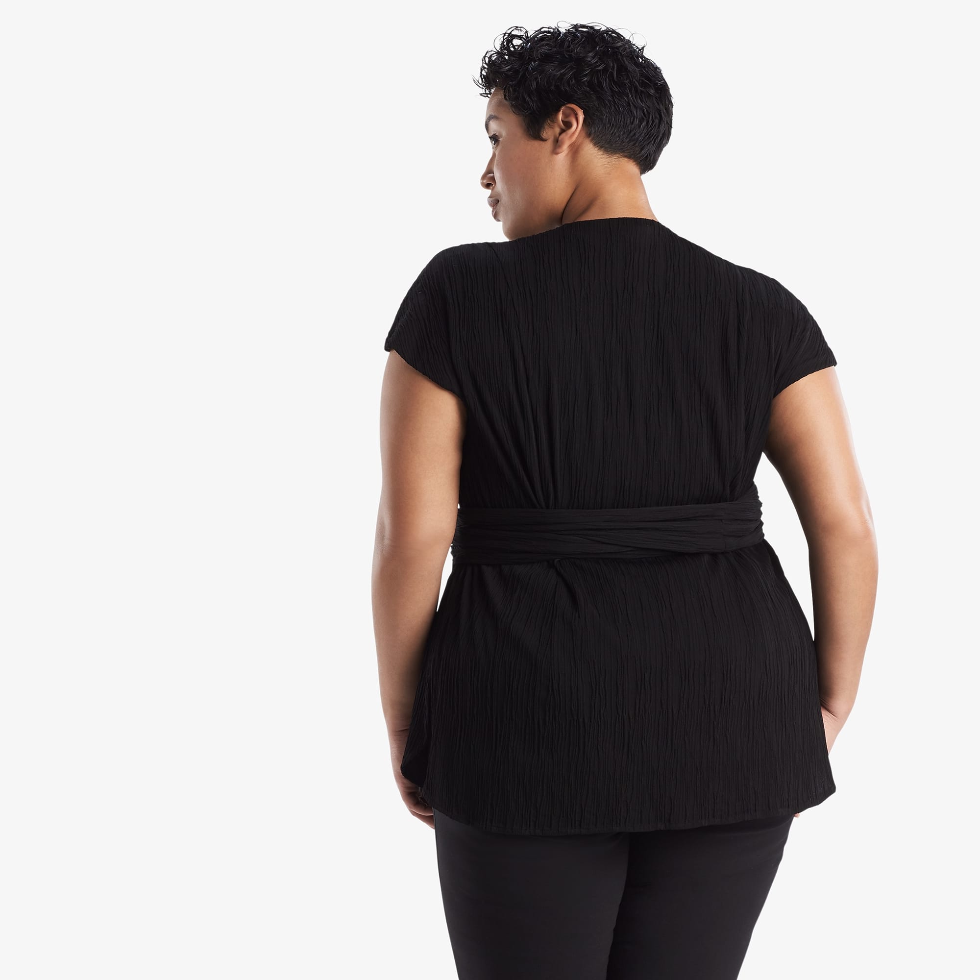 Back image of a woman standing wearing the Valerie Top in black