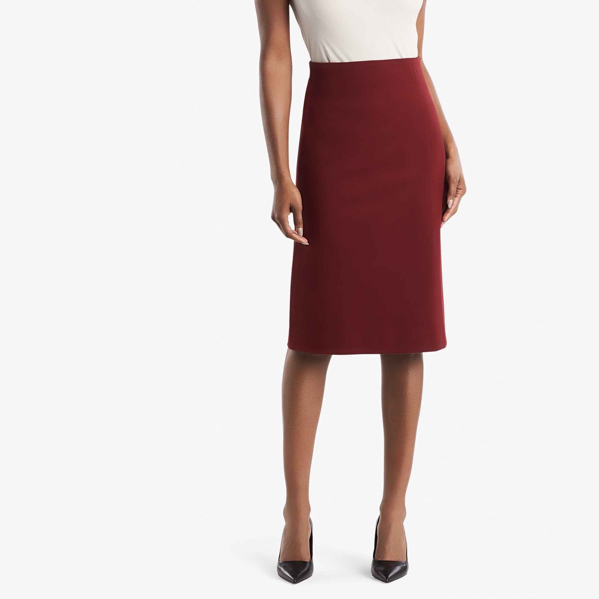 Front image of a woman standing wearing the Dorchester skirt in pinot 