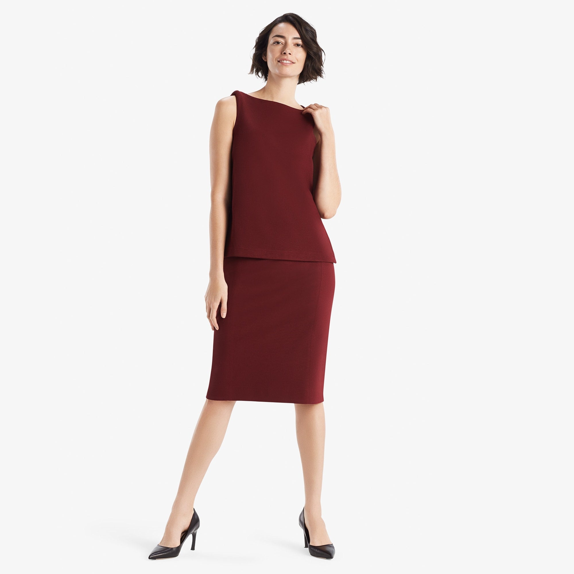 Front image of a woman standing wearing the Dorchester skirt in pinot