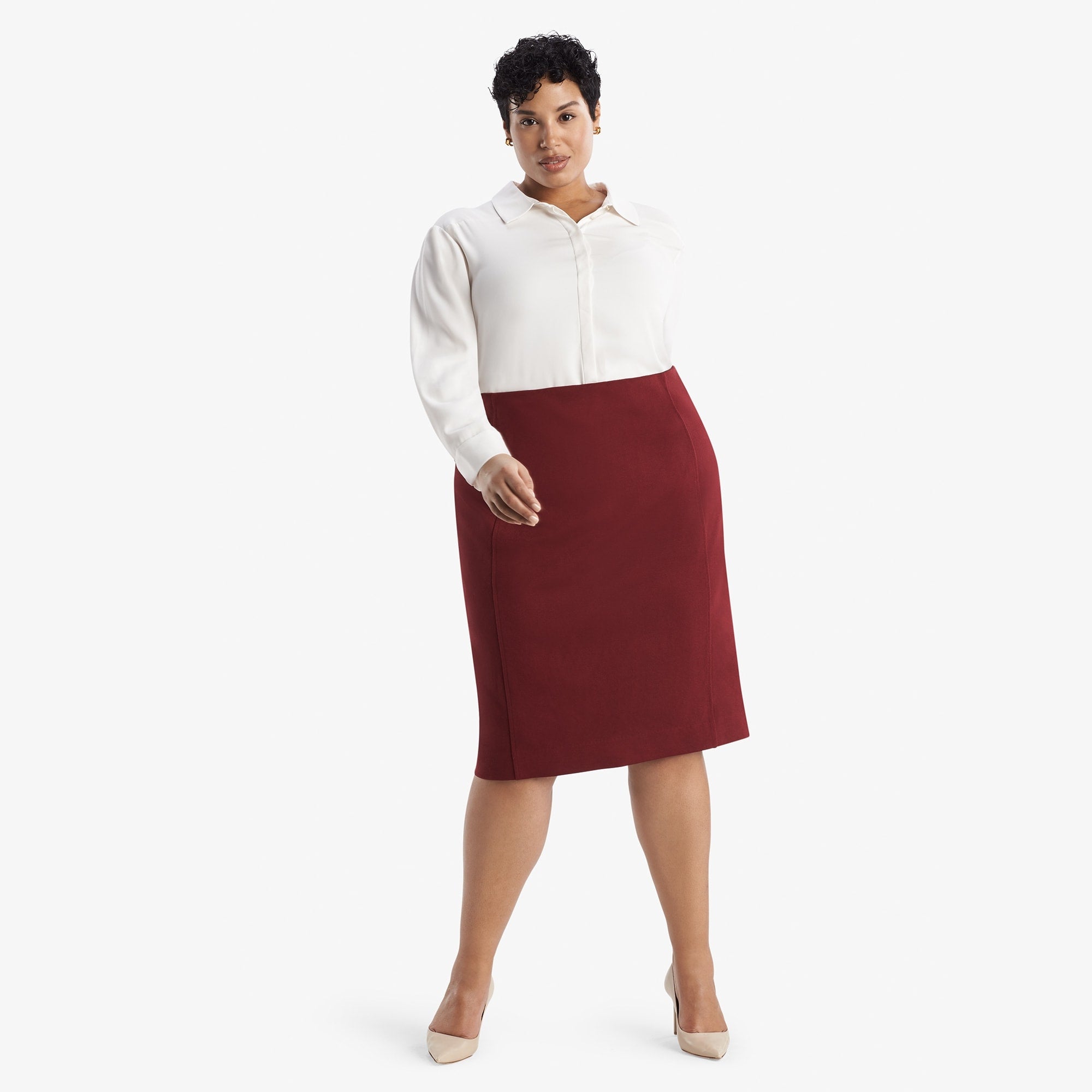 Front image of a woman standing wearing the Dorchester skirt in pinot