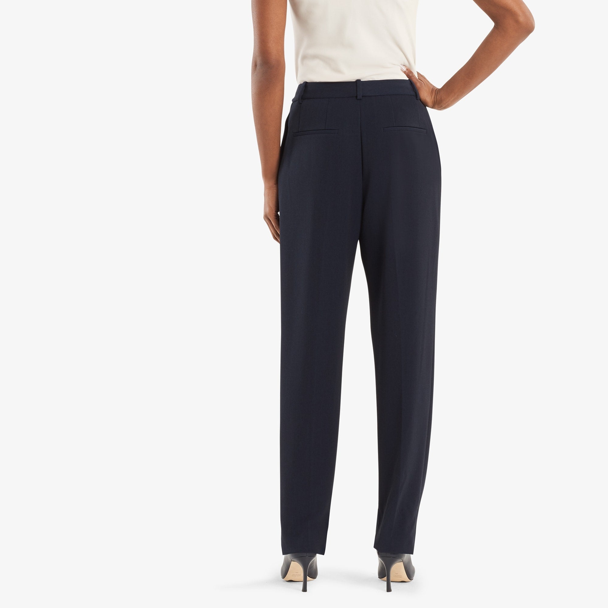 Back image of a woman standing wearing the Elliott trouser in navy.