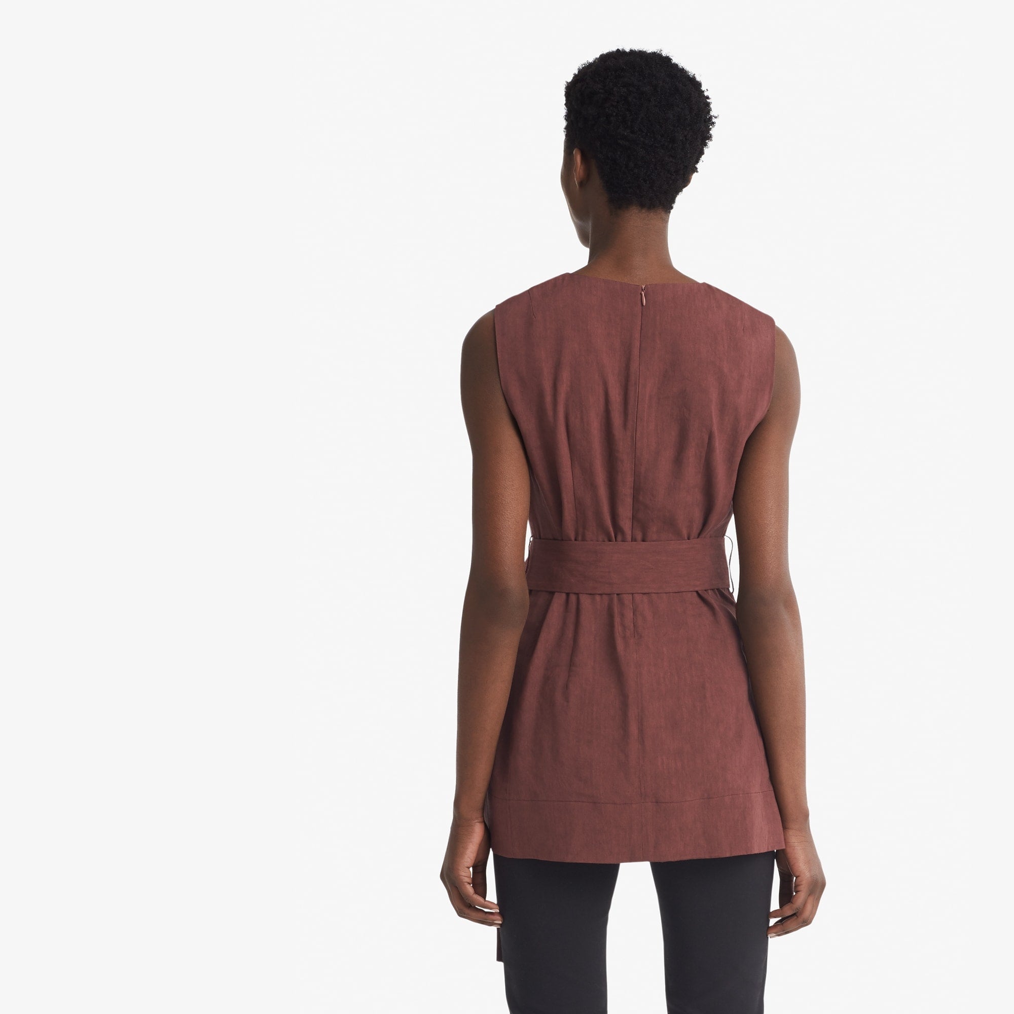 Back image of a woman standing wearing the Angelina top stretch linen in sumac