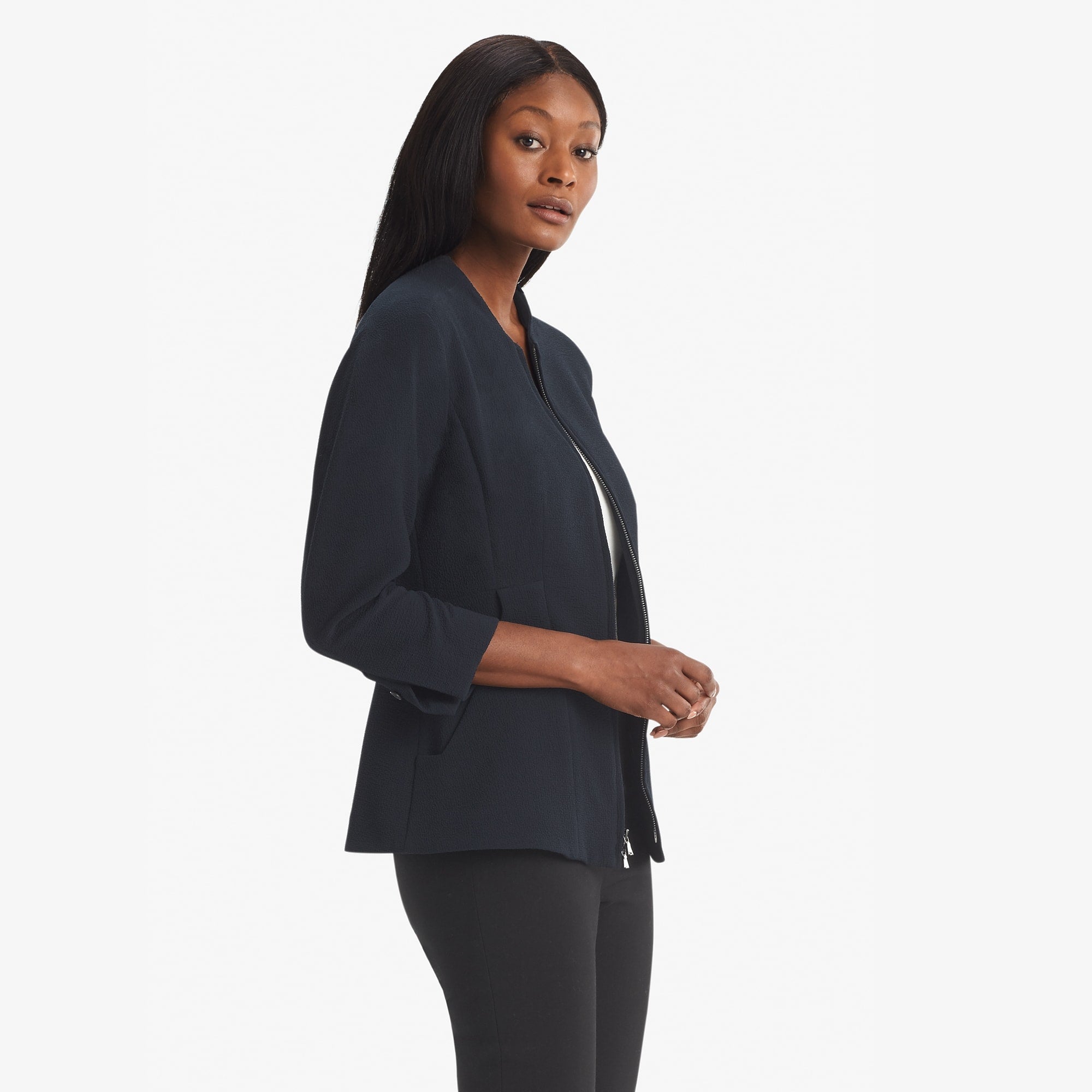 Side image of a woman standing wearing the Higgins jacket staccato in galaxy blue
