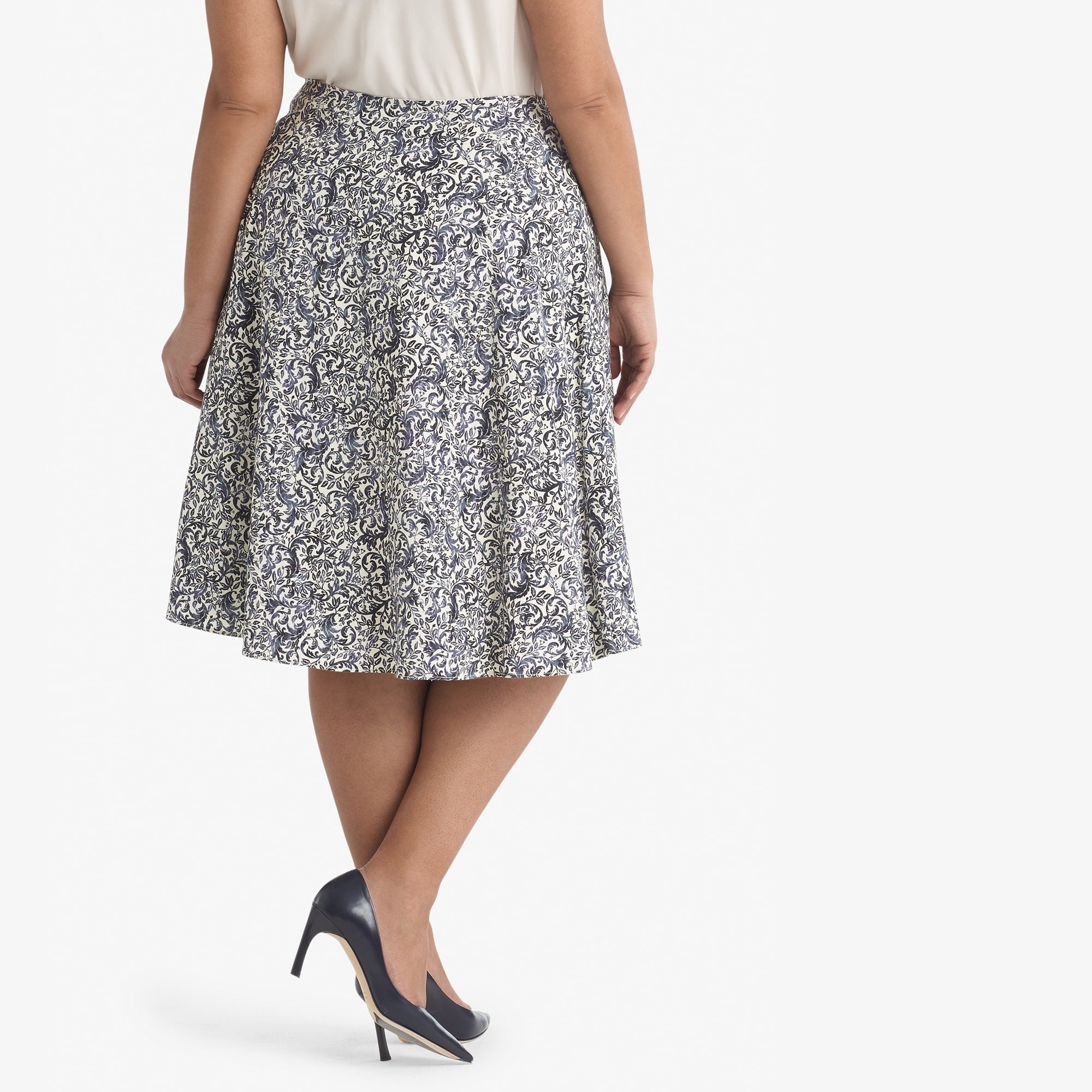Back image of a woman standing wearing the Hopson skirt Ivy Print in galaxy blue