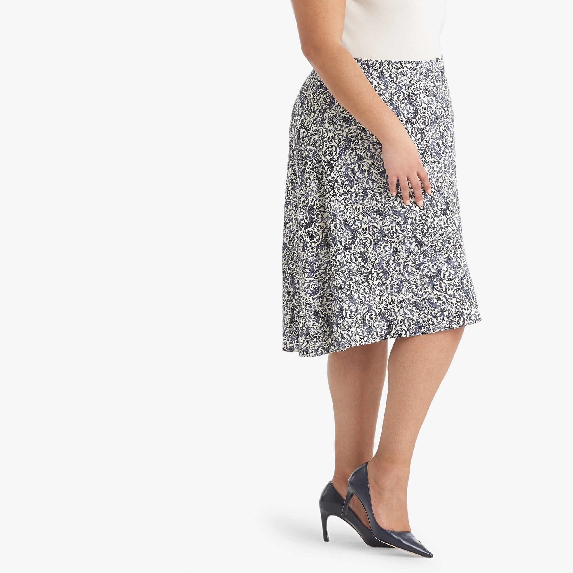Side image of a woman standing wearing the Hopson skirt Ivy Print in galaxy blue