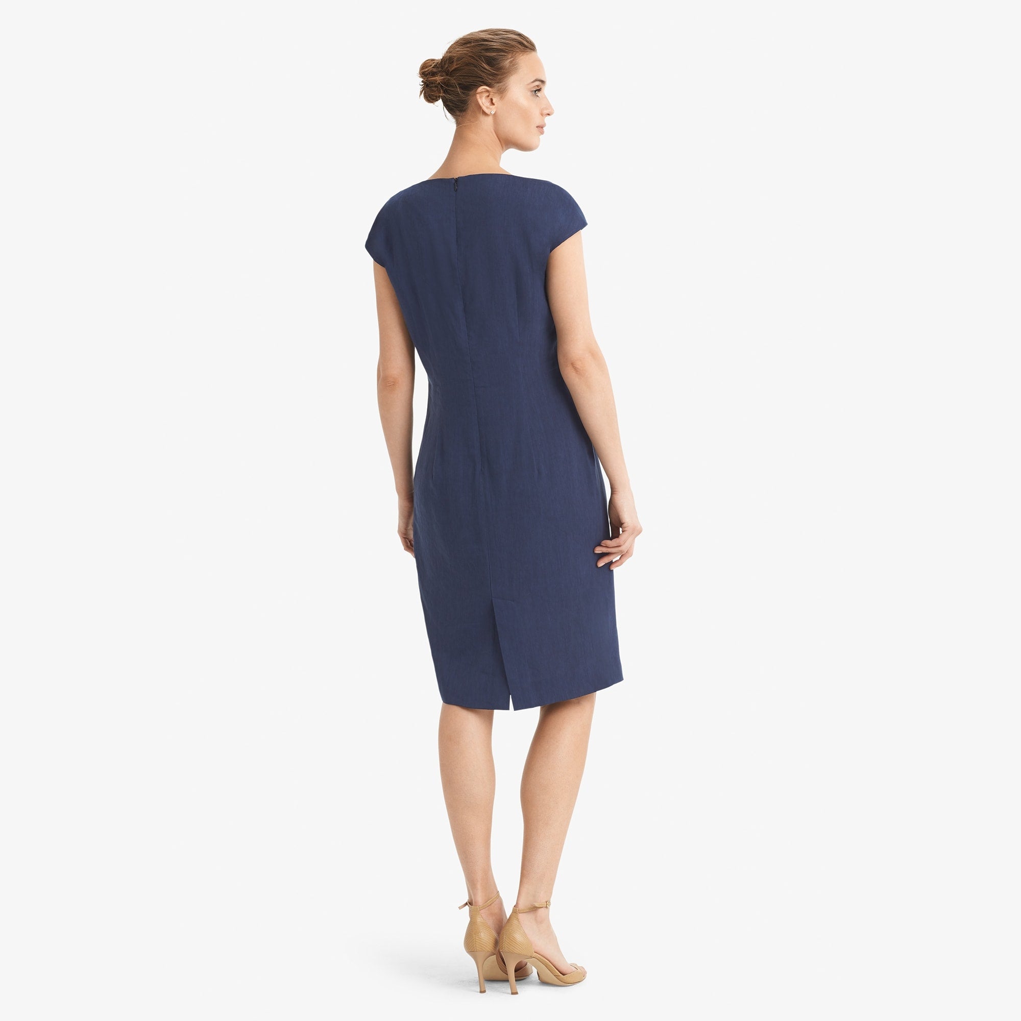 Back image of a woman standing wearing the Marilyn dress stretch linen in blueberry