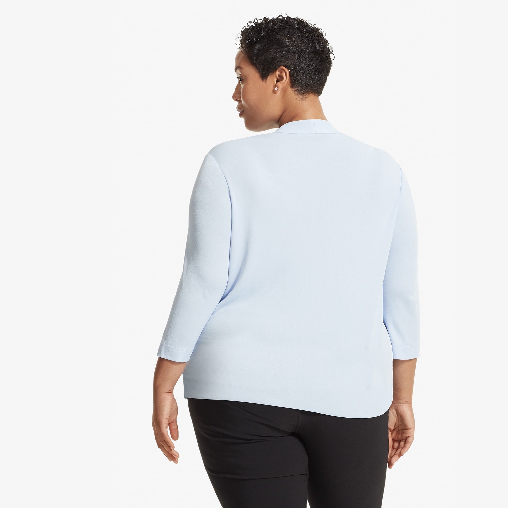 Back image of a woman standing wearing the Deneuve top in Oxford Blue