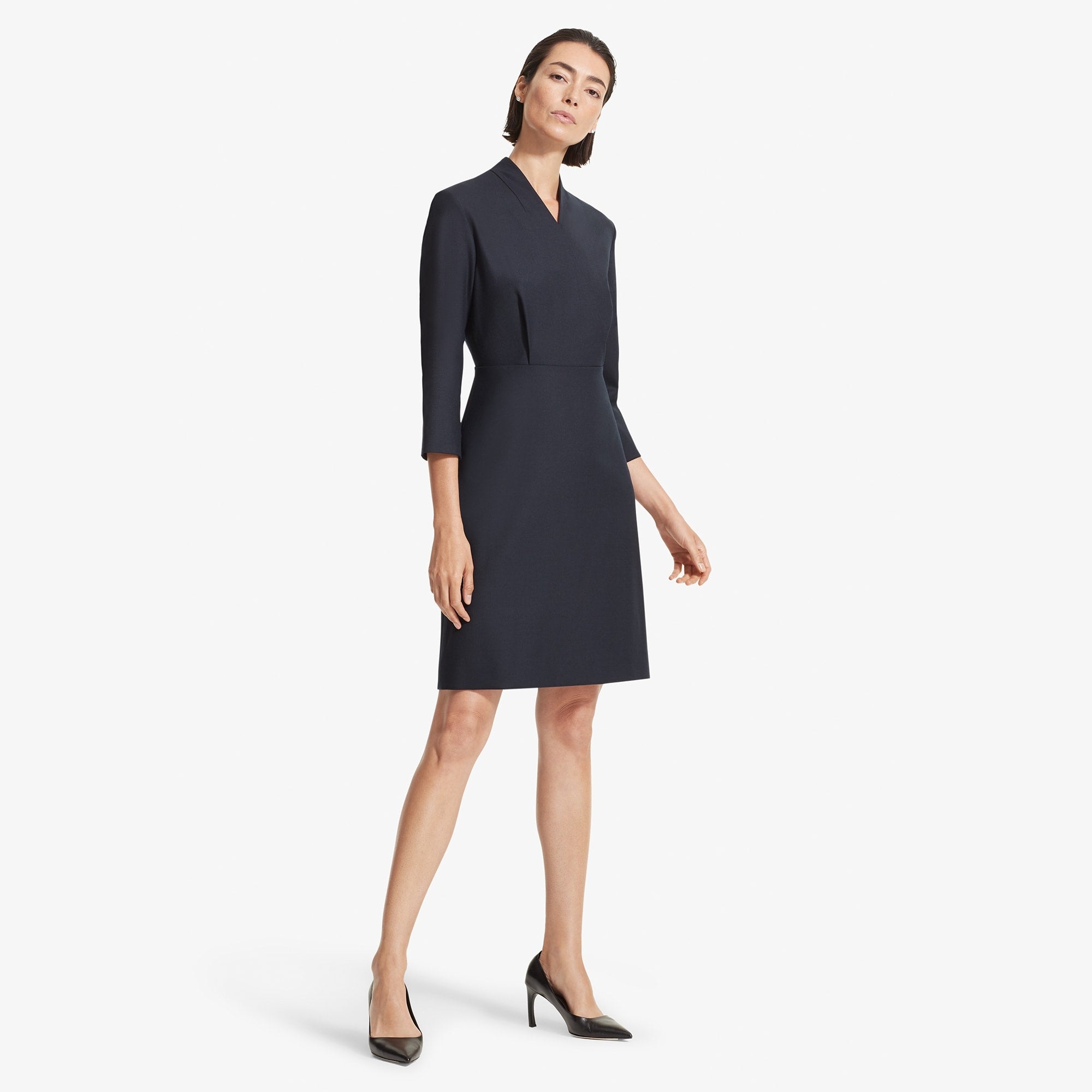 Front image of a woman standing wearing the Niko dress sharkskin in Ink 