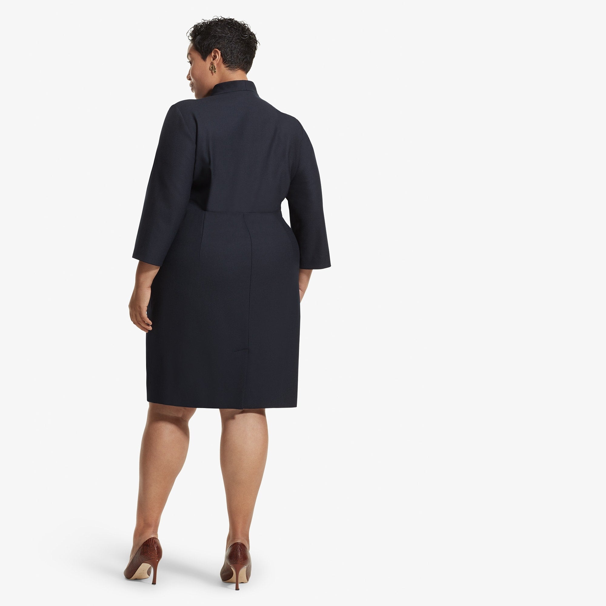 Back image of a woman standing wearing the Niko dress sharkskin in Ink