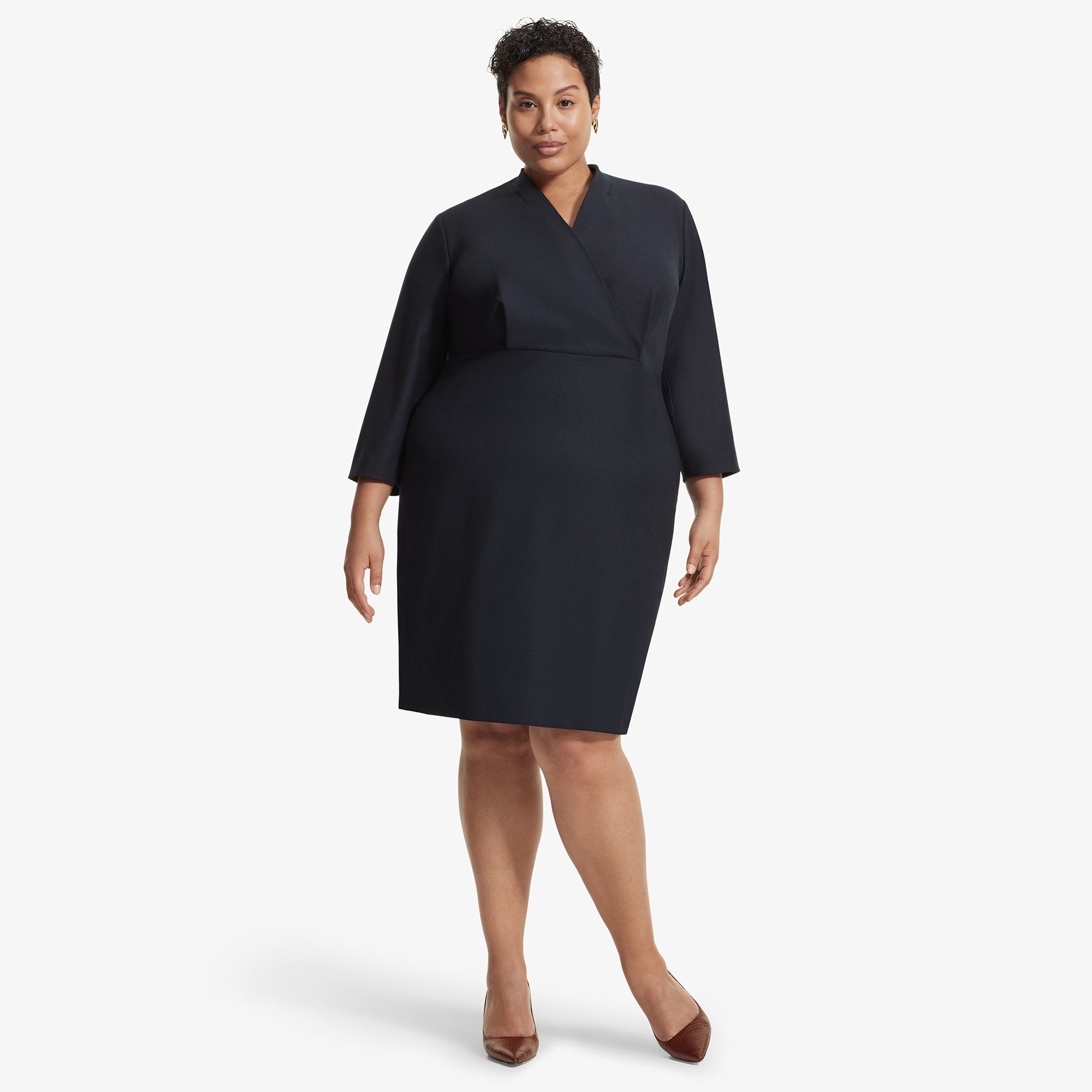 Front image of a woman standing wearing the Niko dress sharkskin in Ink