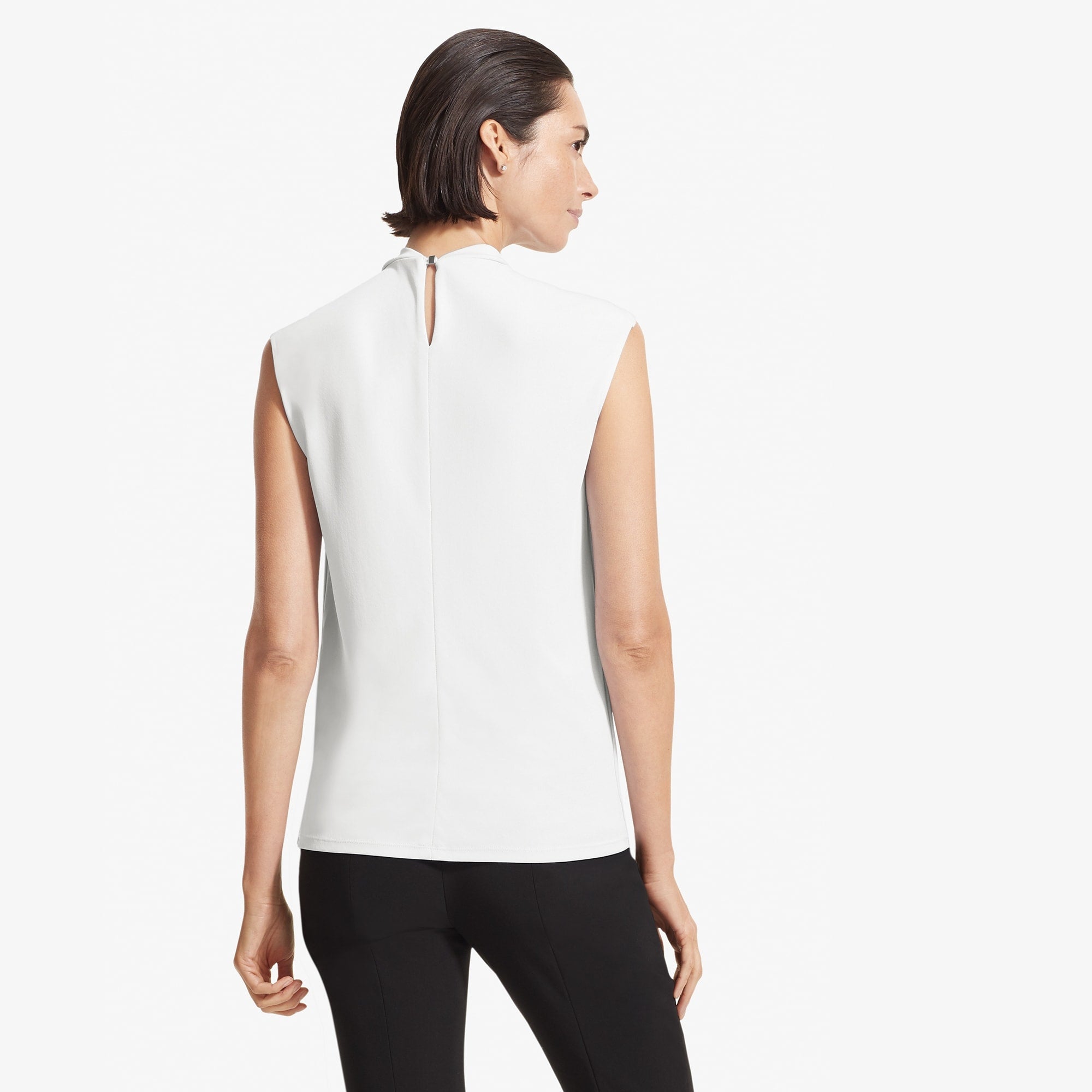 Back image of a woman standing wearing the Walters top knit crepe in Ivory