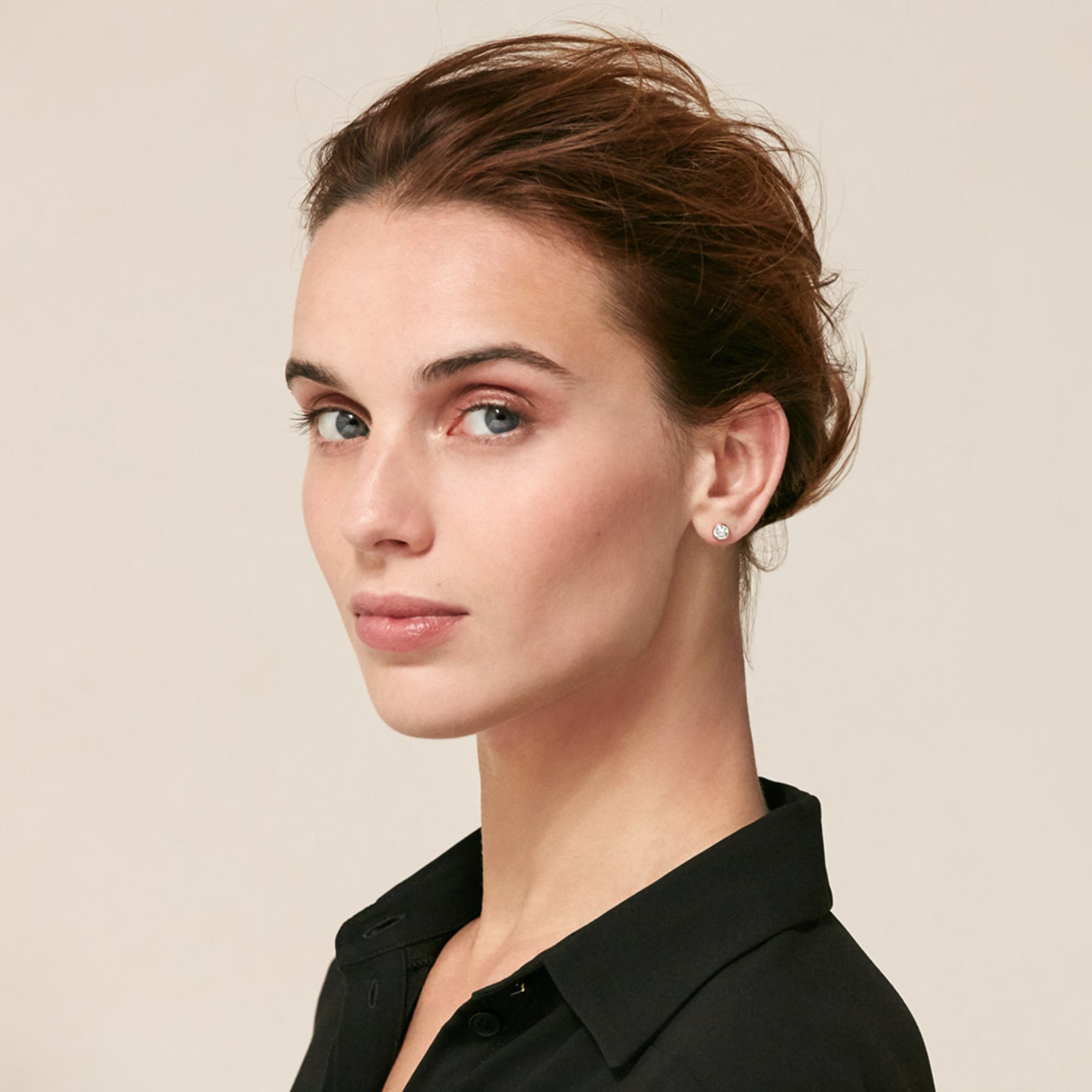 Front image of woman wearing the Bezel Earrings in Gold