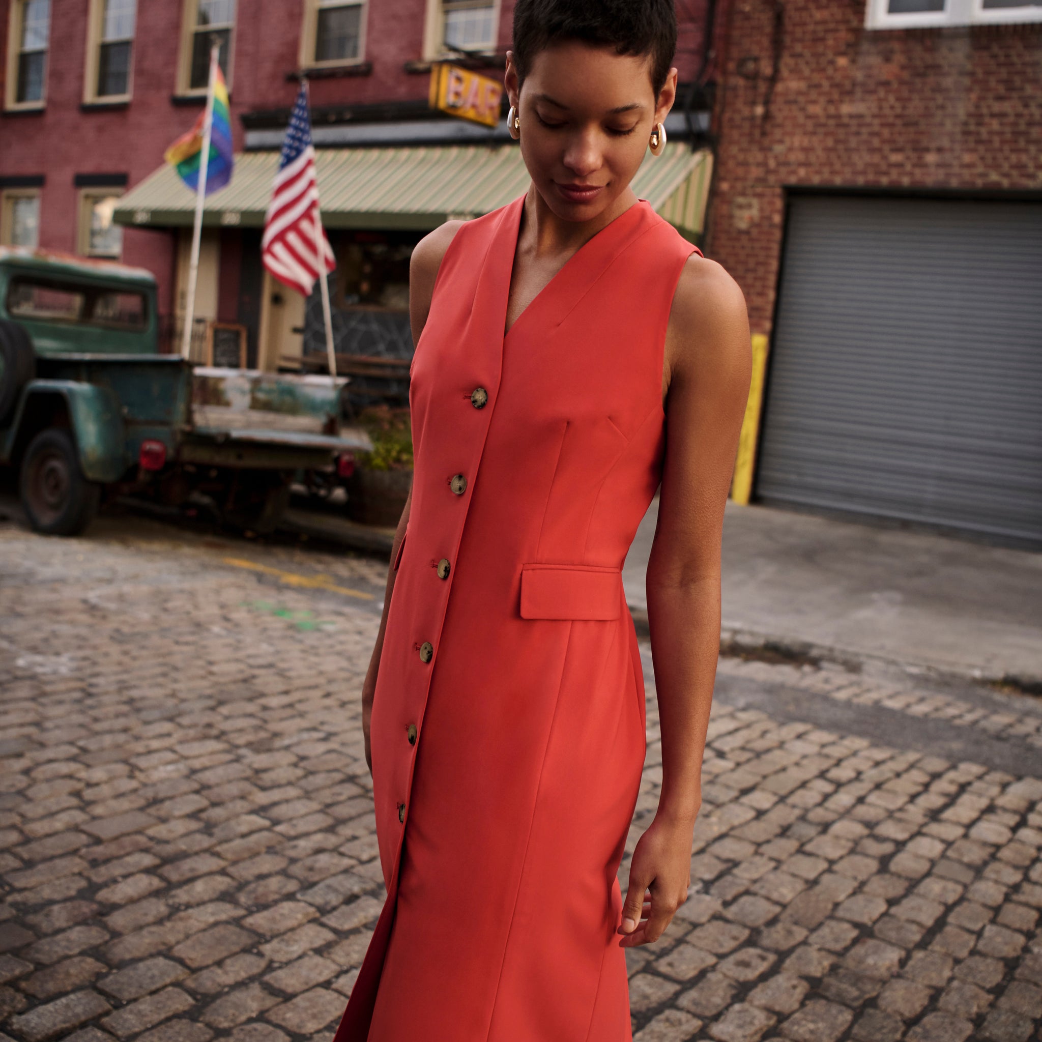 Front image of a woman wearing the Cassandra Dress in Blood Orange
