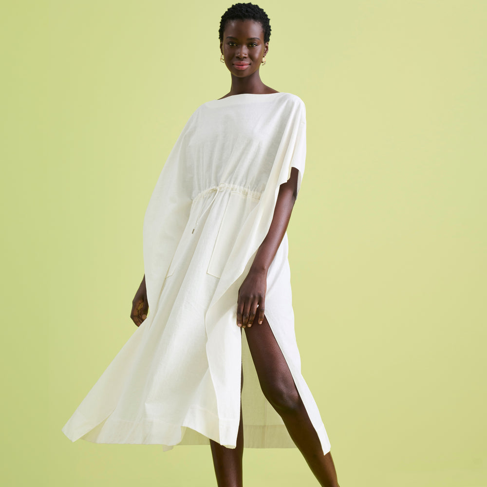 Front image of a woman wearing the Freedlund Caftan in Ivory