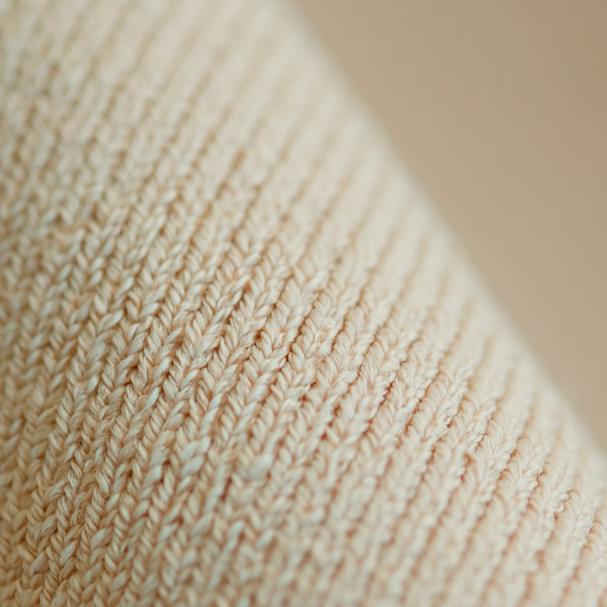 Close up image of jardigan knit fabric in latte