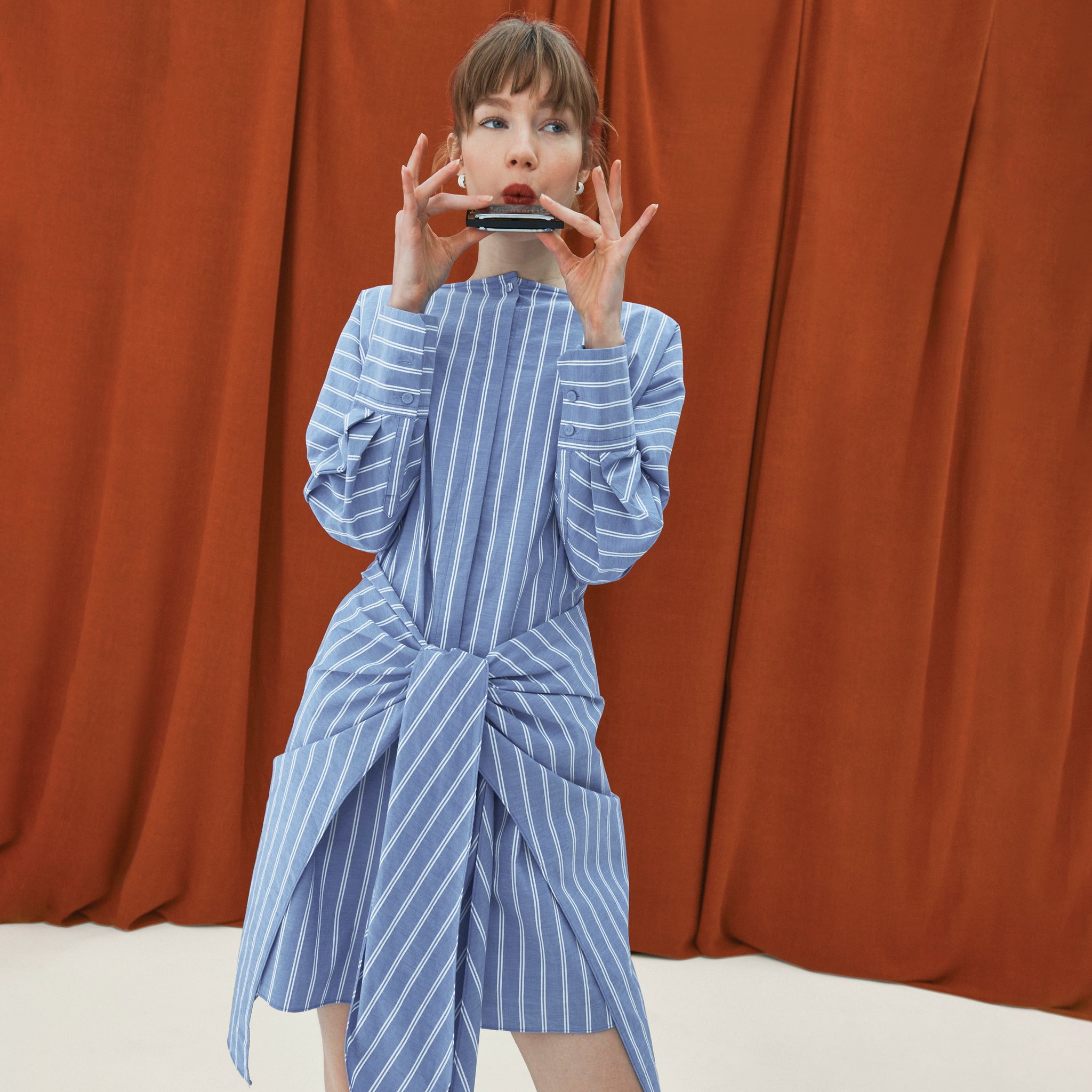 front image of a woman wearing the janie dress in poplin stripe