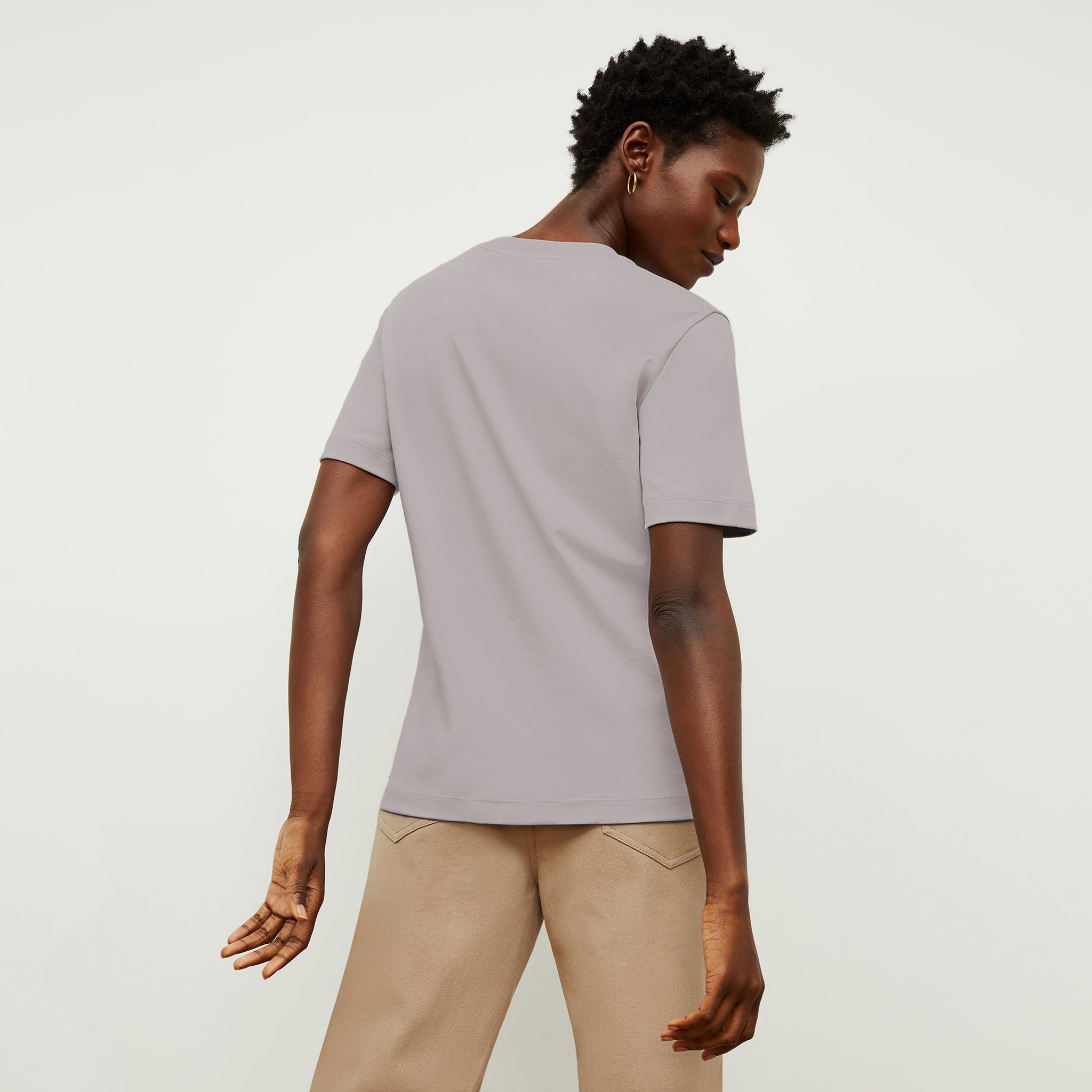 back image of a woman wearing the leslie shirt in wisteria