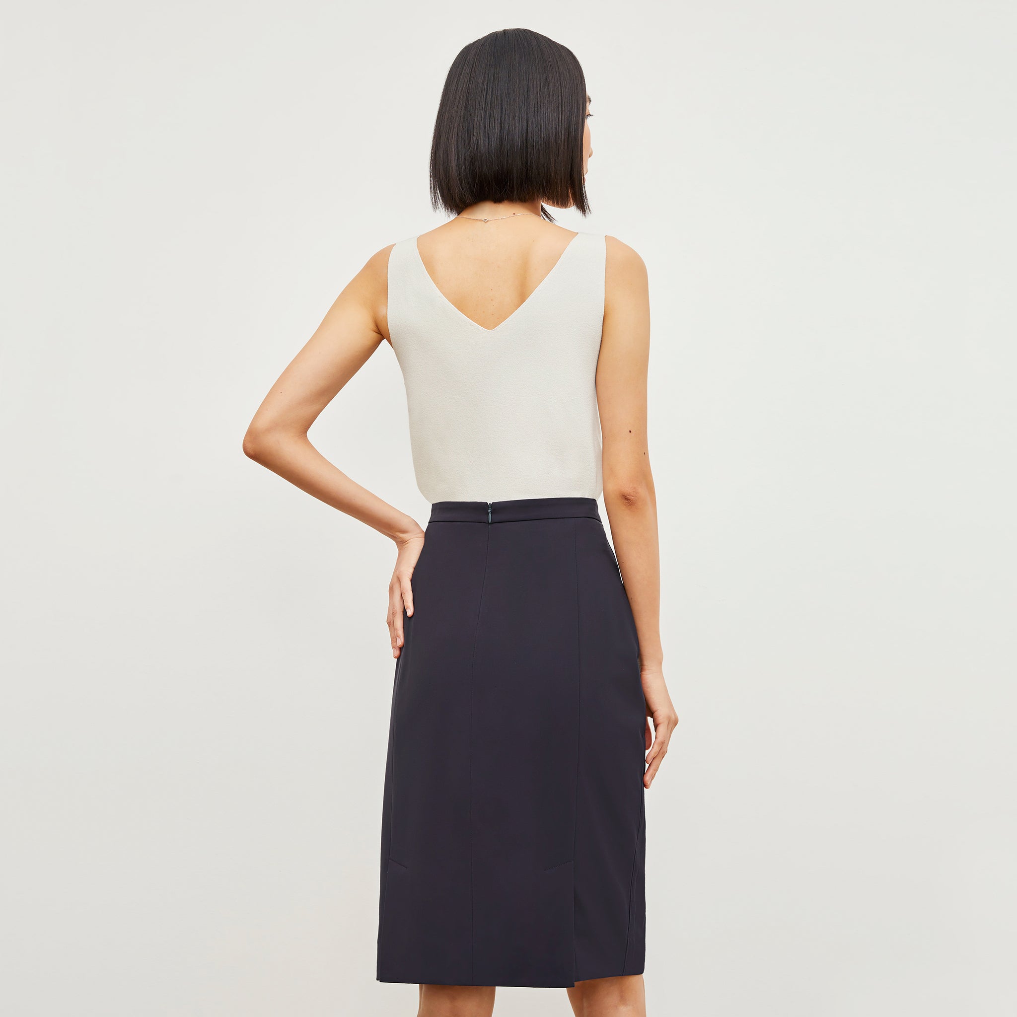 Back image of a woman wearing the Cobble Hill Skirt - OrigamiTech in Cool Charcoal