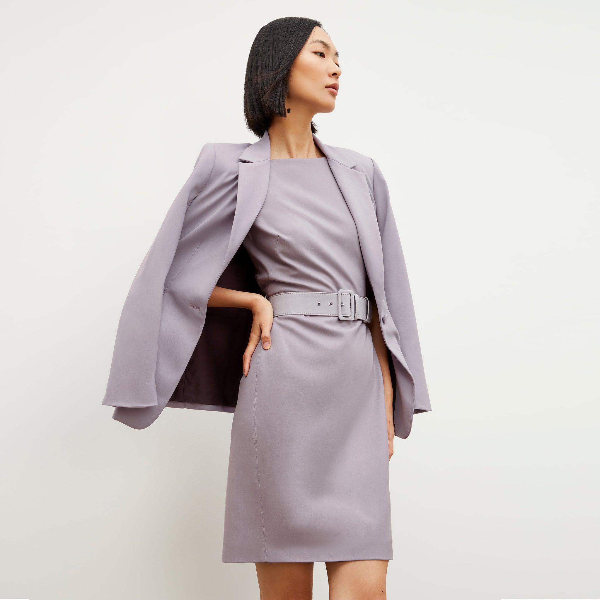 Side image of a woman wearing the Cynthia Dress - Washable Wool Twill in Light Lilac