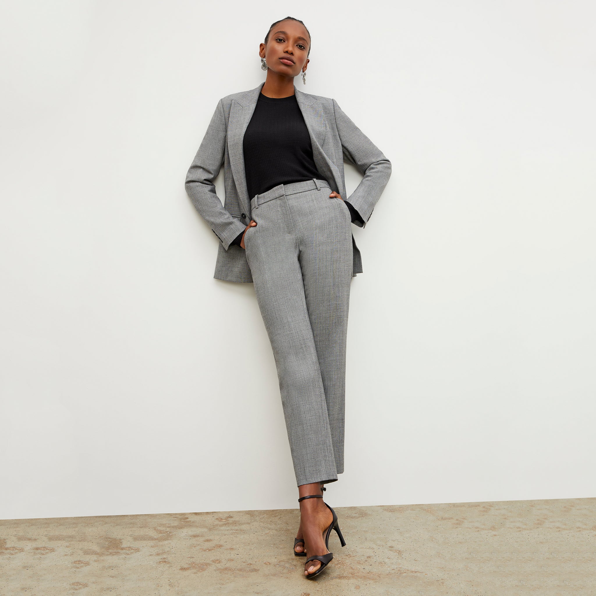 Front image of a woman standing wearing the Mejia pant sharkskin in Black and white'