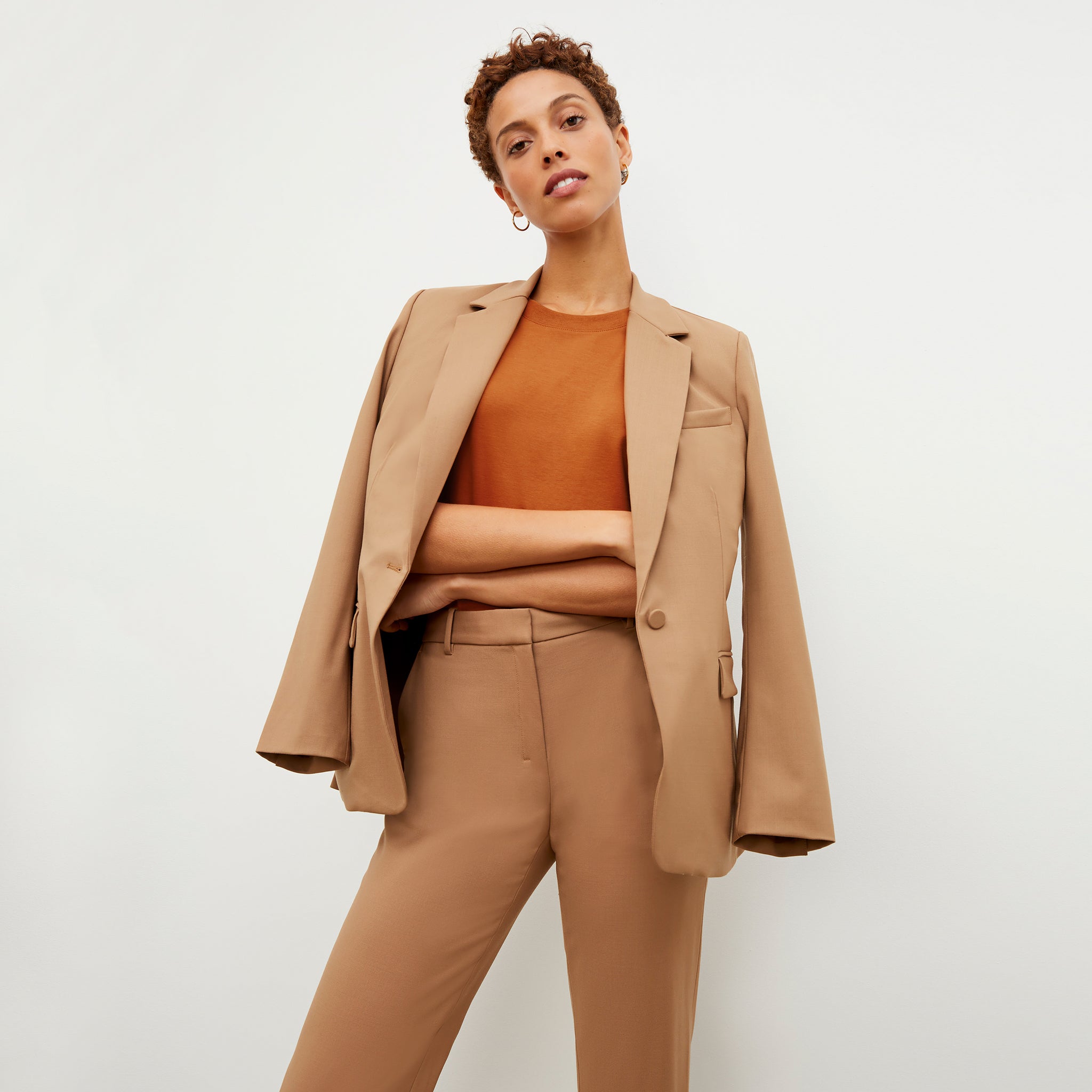 Front image of a woman standing wearing the Mejia pant in camel