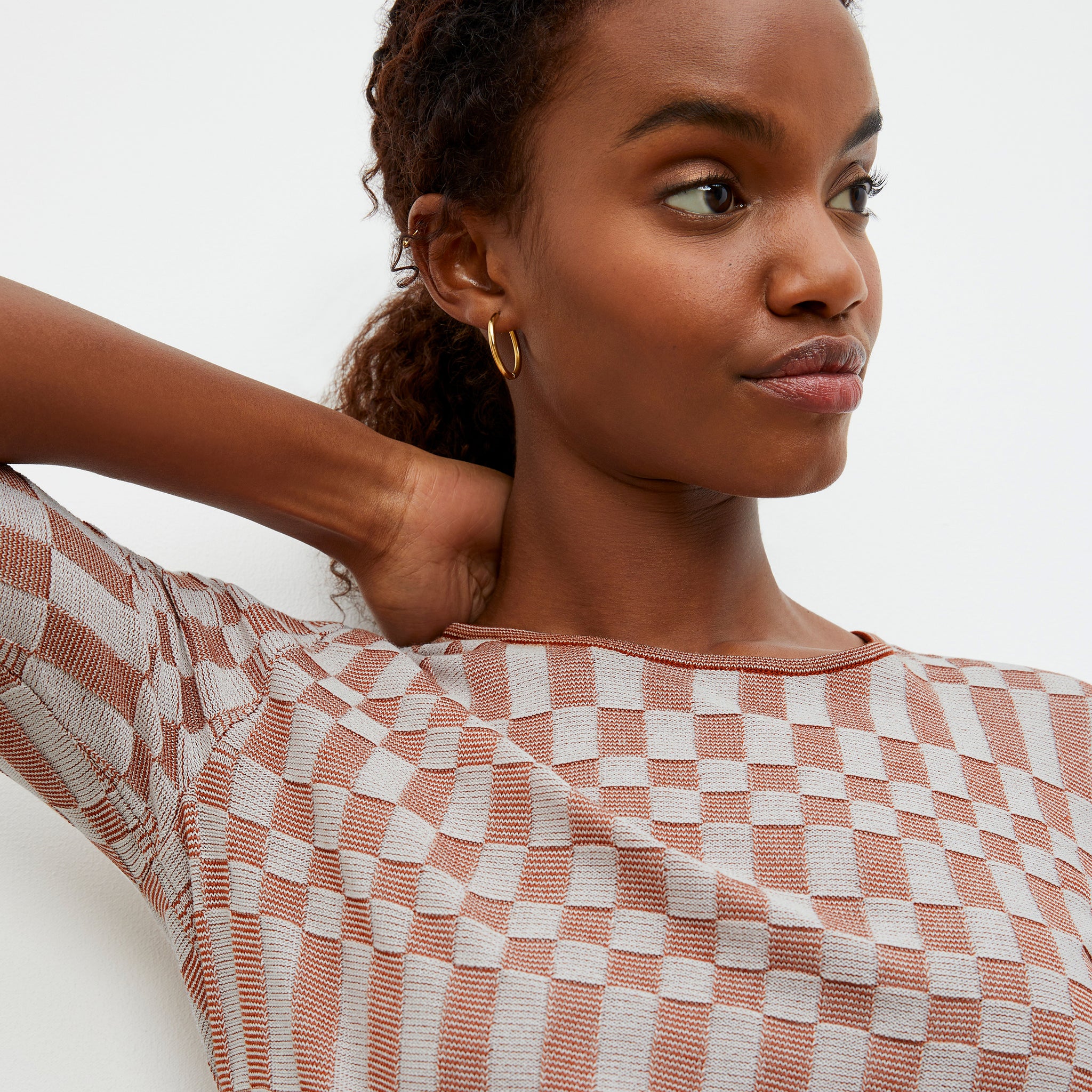 Detail image of a woman wearing the Charli Top - Checkered Knit in Red Clay / Natural