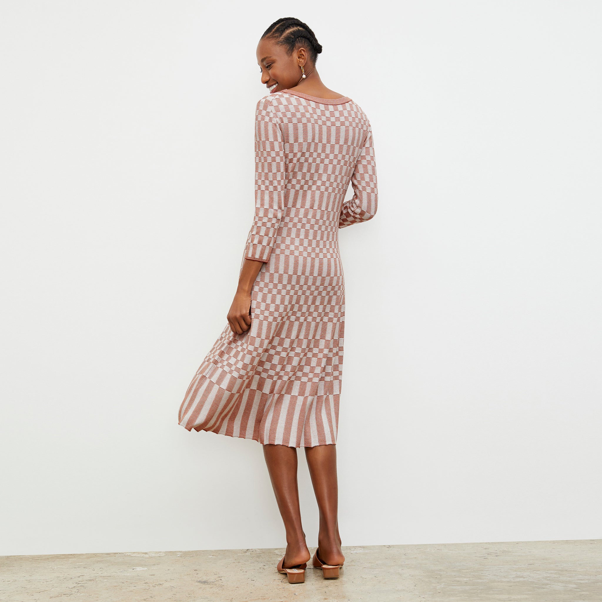 Back image of a woman wearing the Tippy Dress - Checkered Knit in Red Clay / Natural