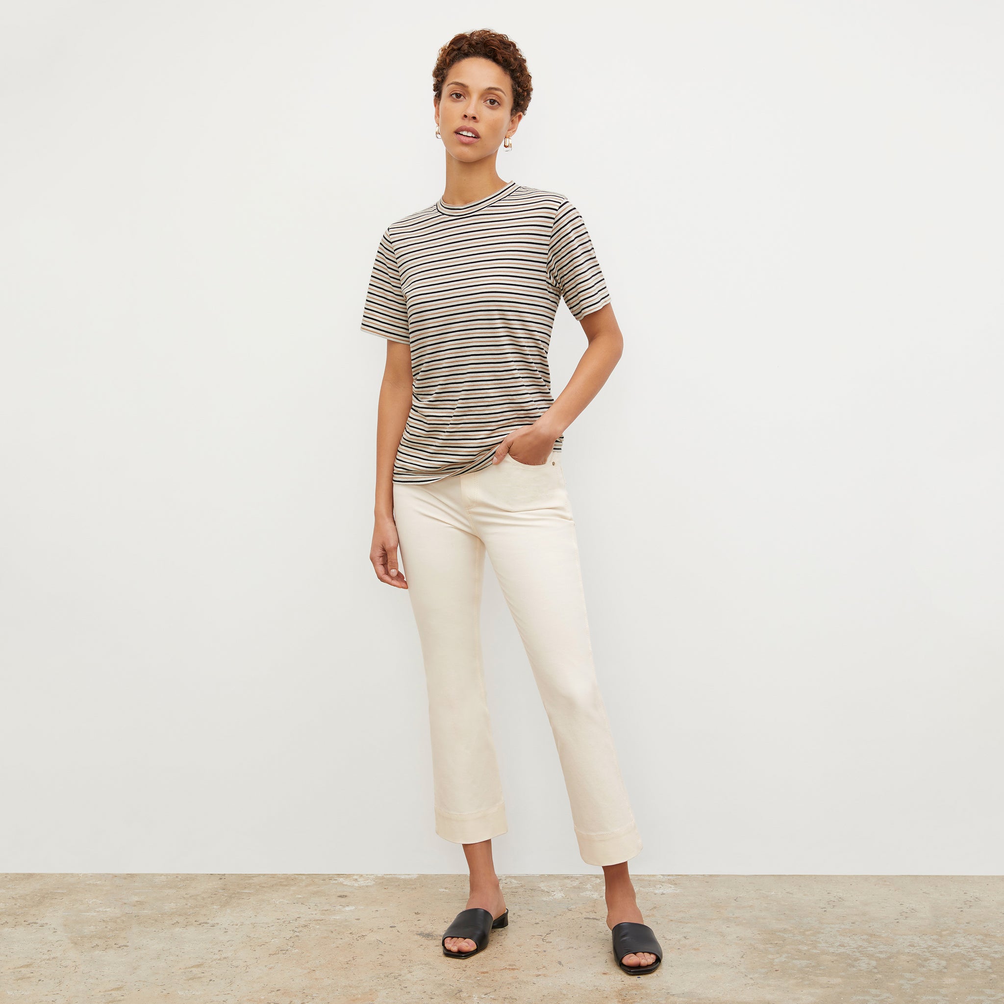 Front image of a woman wearing the Leslie T-Shirt - Thin Striped Pima Cotton in Tan / Black 
