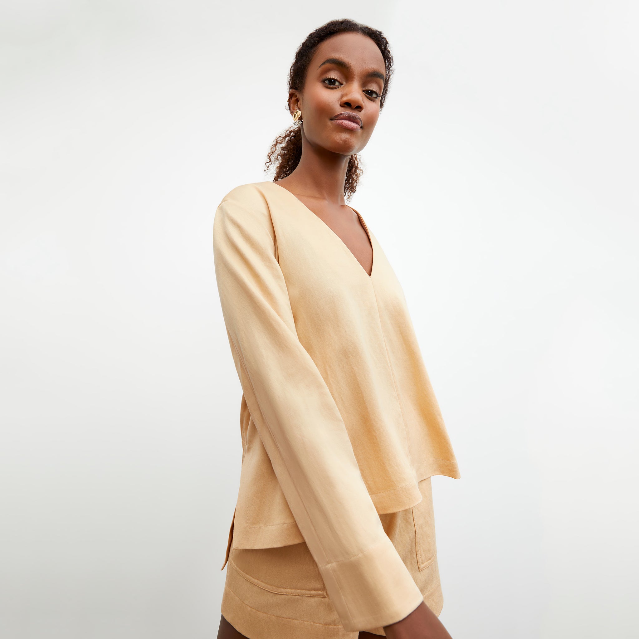 Side image of a woman wearing the Annette Top - Everyday Twill in Butter