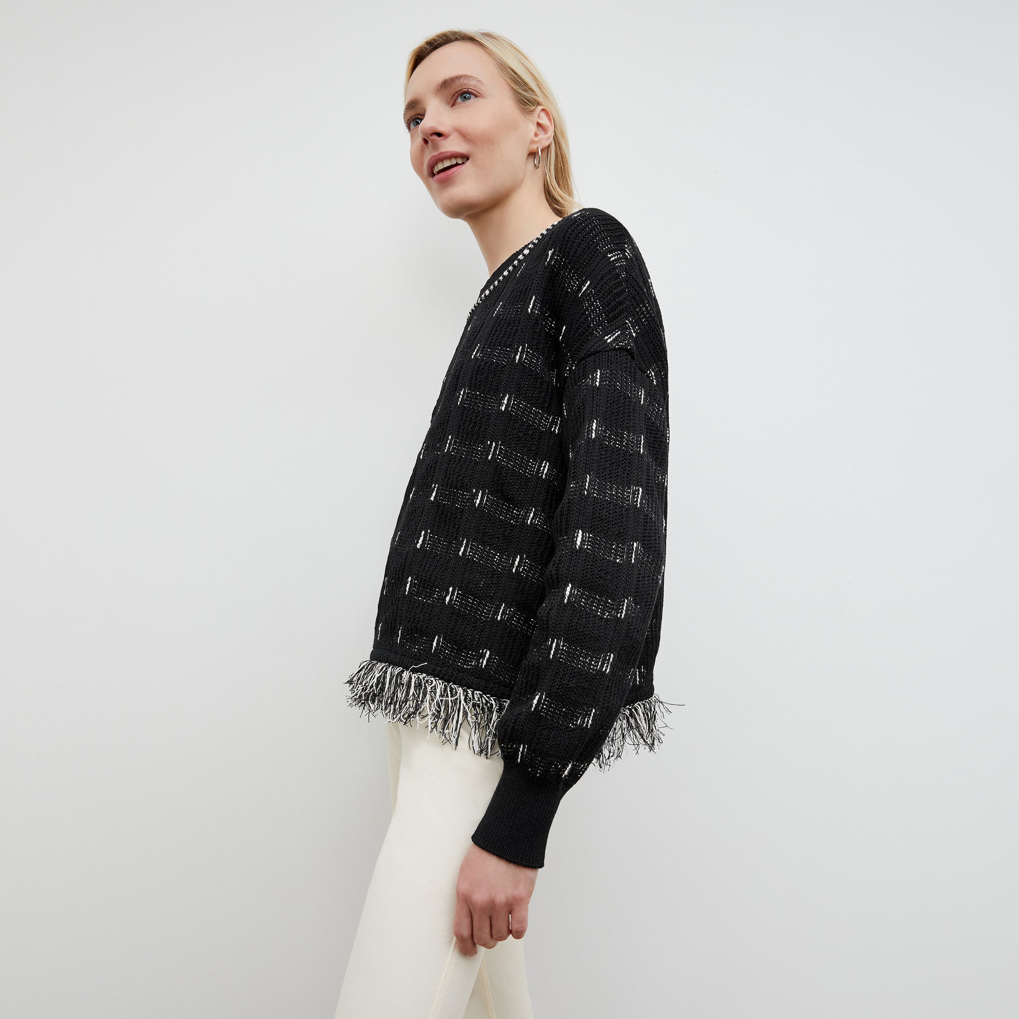 Side image of a woman wearing the Figari Pullover - Linear Interweave in Black / White