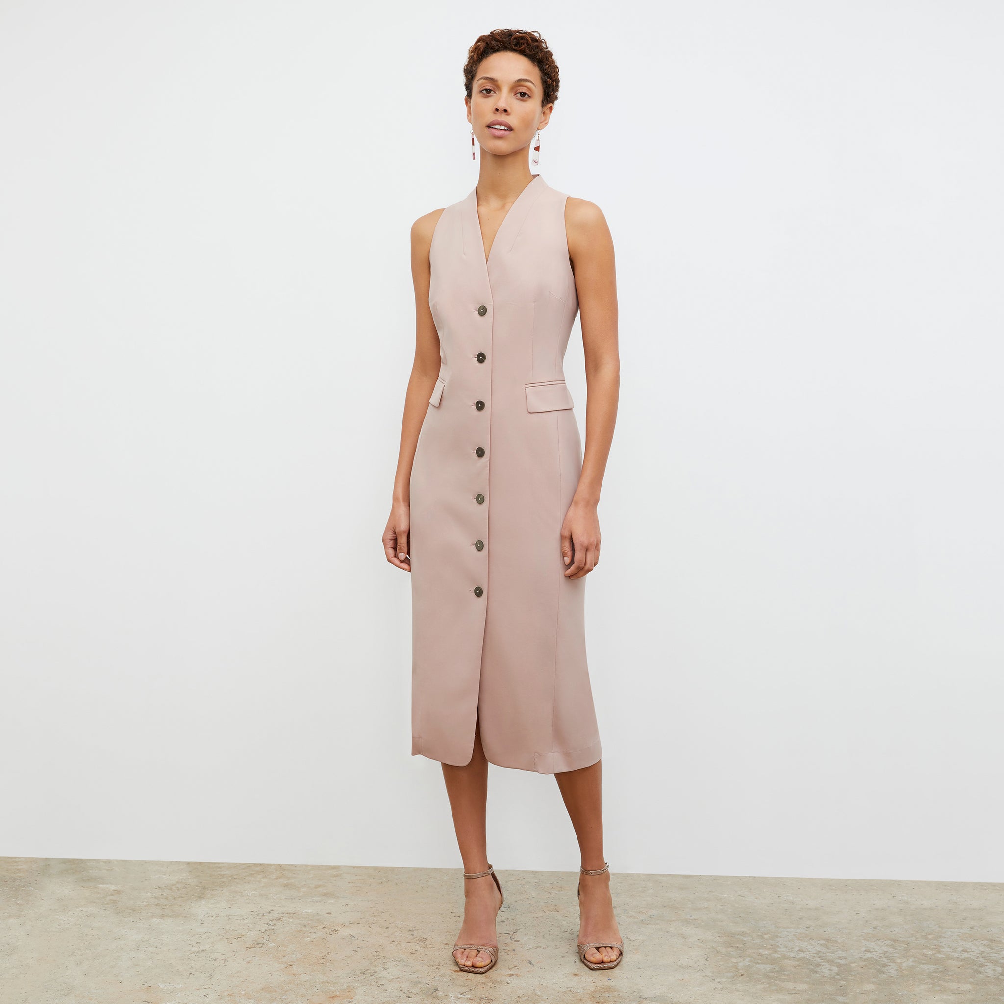 Front image of a woman wearing the Cassandra dress in Blush 