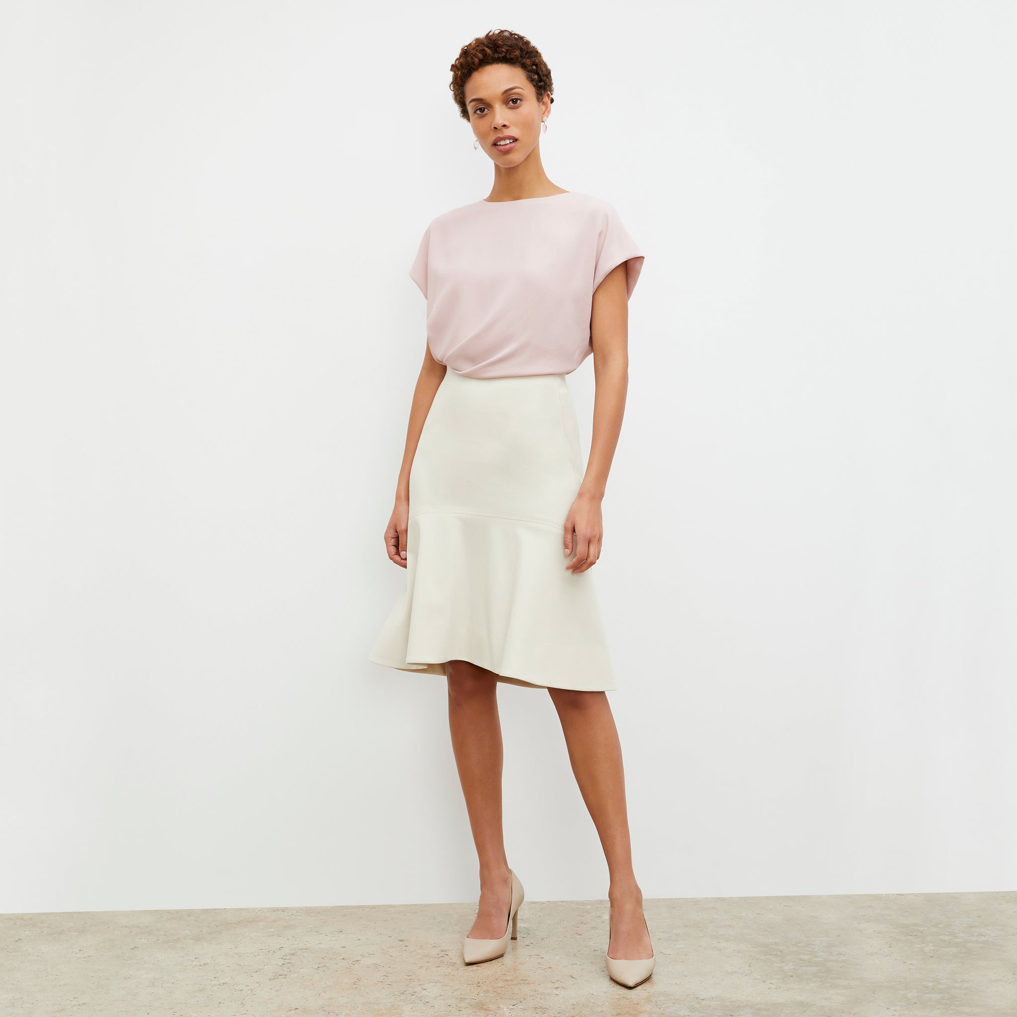 Front image of a woman wearing the Astor Skirt in Pearl 