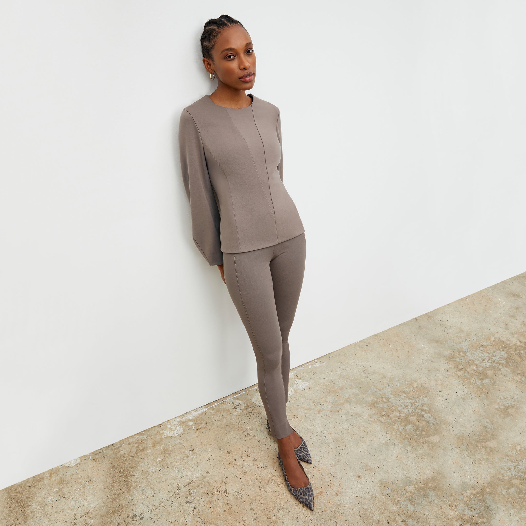 Front image of a woman wearing the Stella legging in Pebble