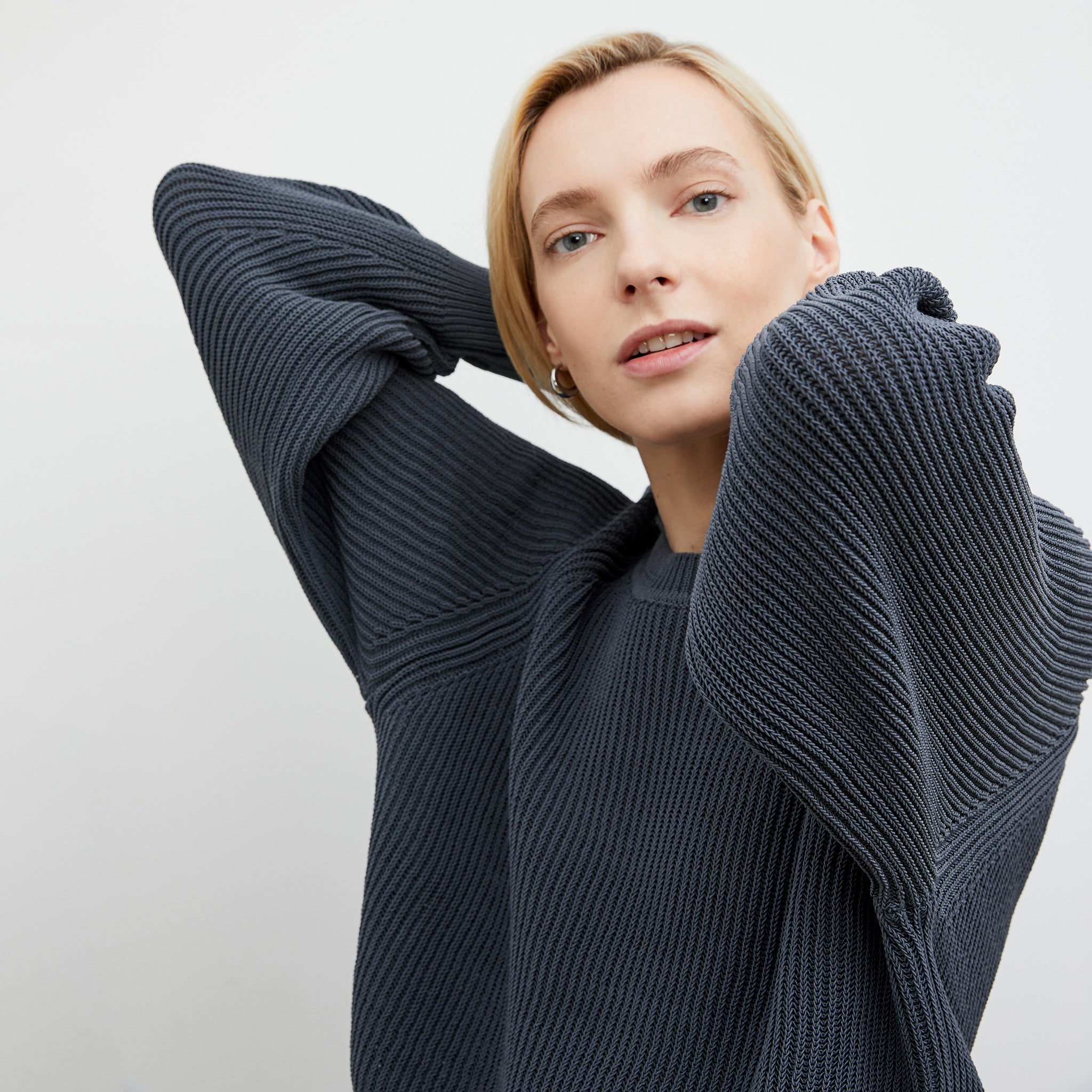 Detail image of a woman wearing the Jo Sweater - Sleek Cotton in Dusty Indigo
