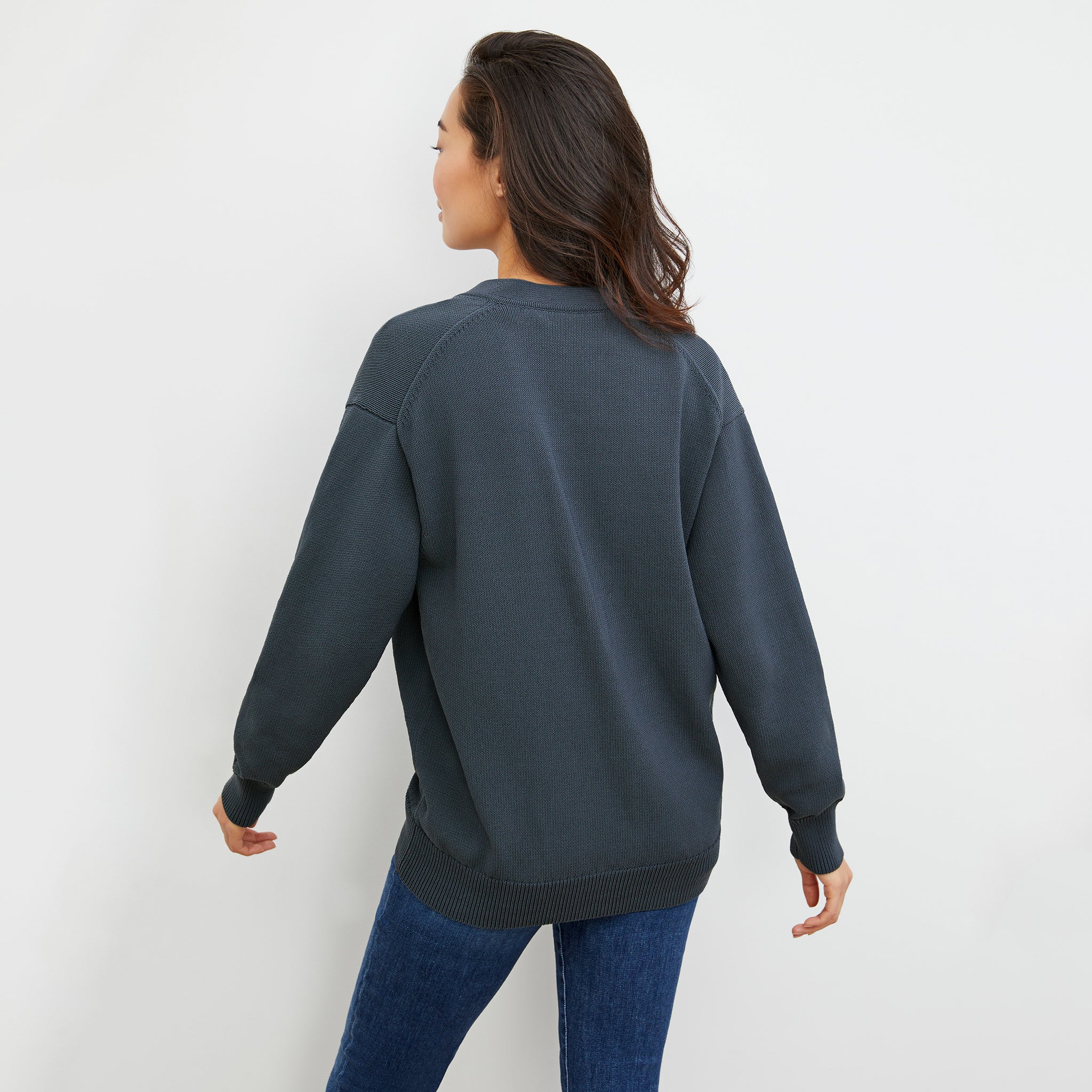 Back image of a woman wearing the Cookie Cardigan - Sleek Cotton in Dusty Indigo
