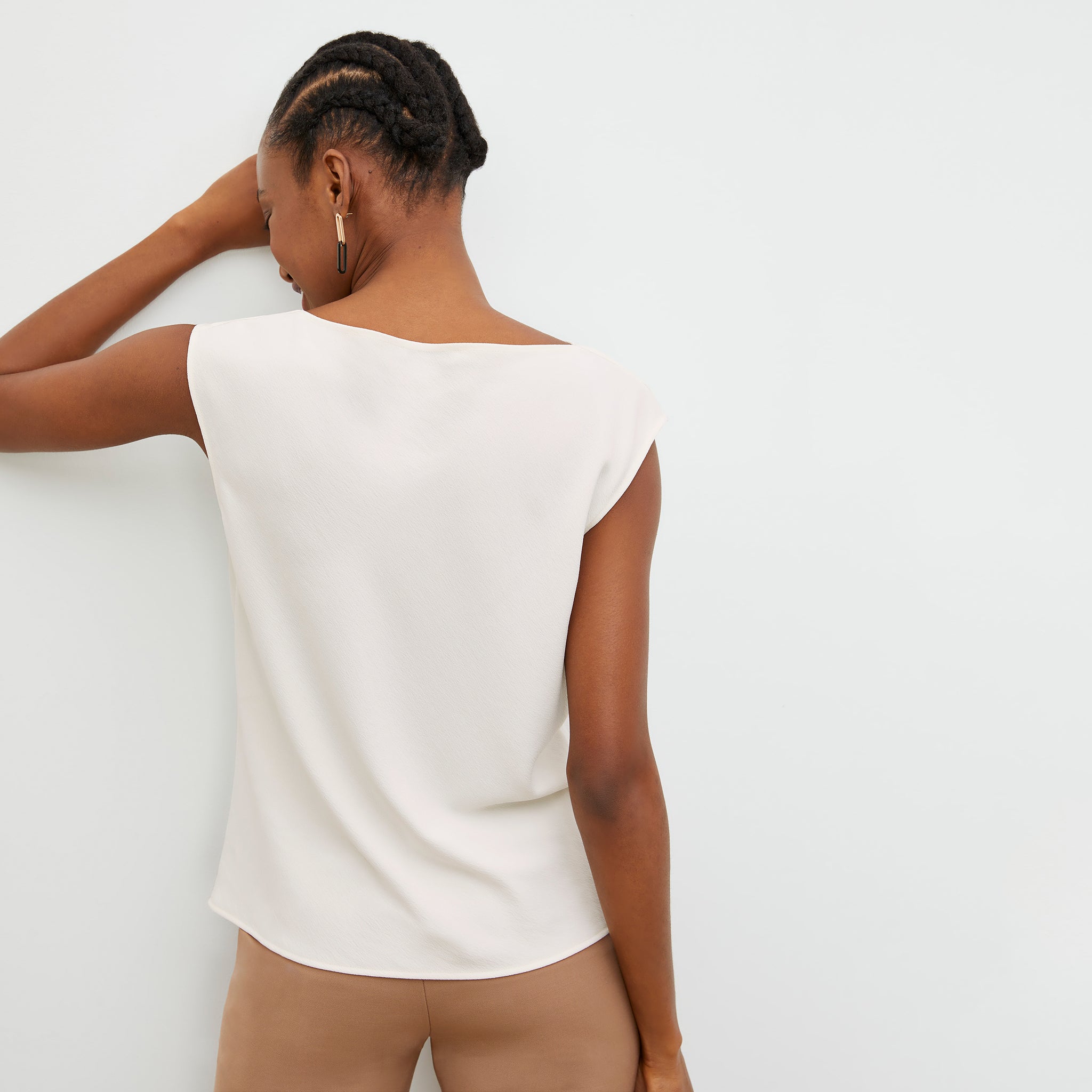 Back image of a woman wearing the Nora Top in Alabaster