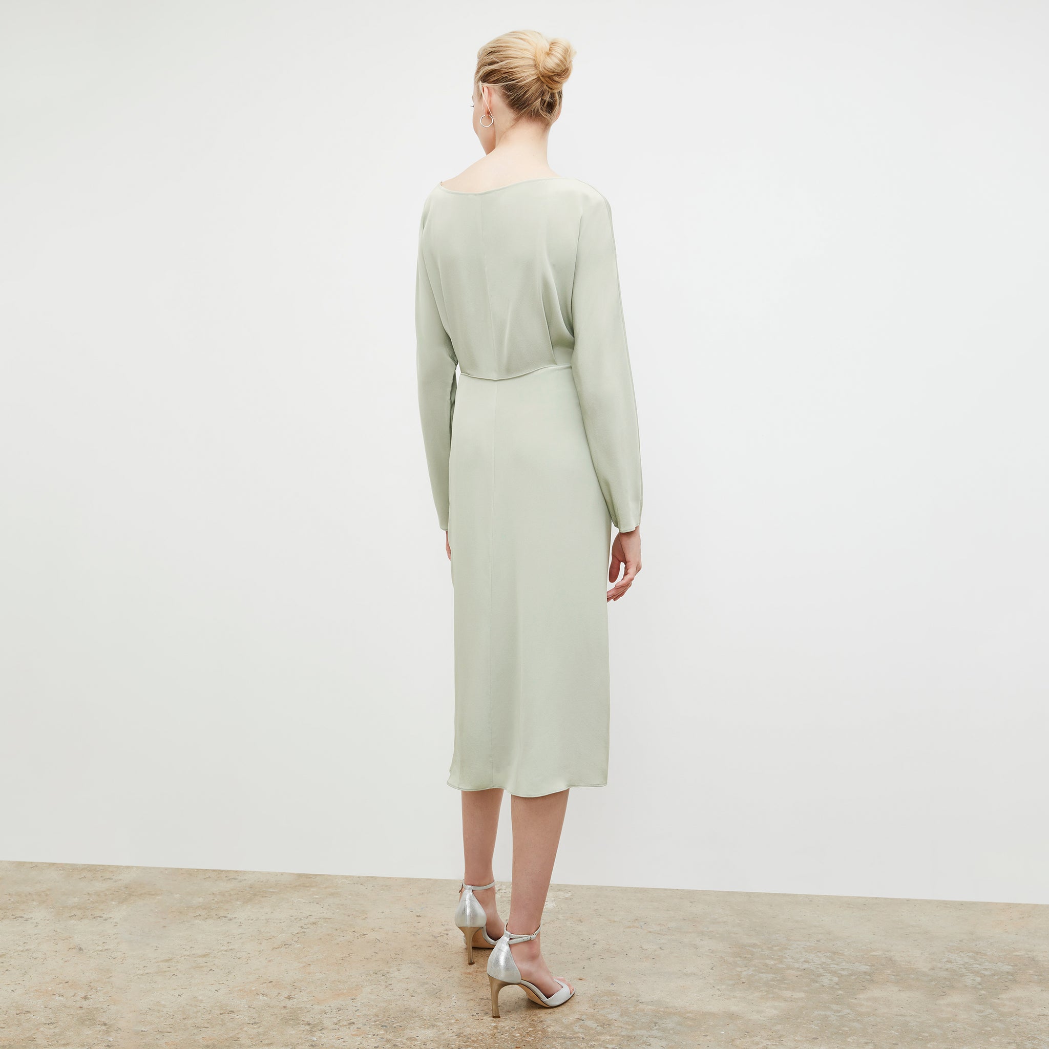 Back image of a woman wearing the Rashmeen dress in Minty Green