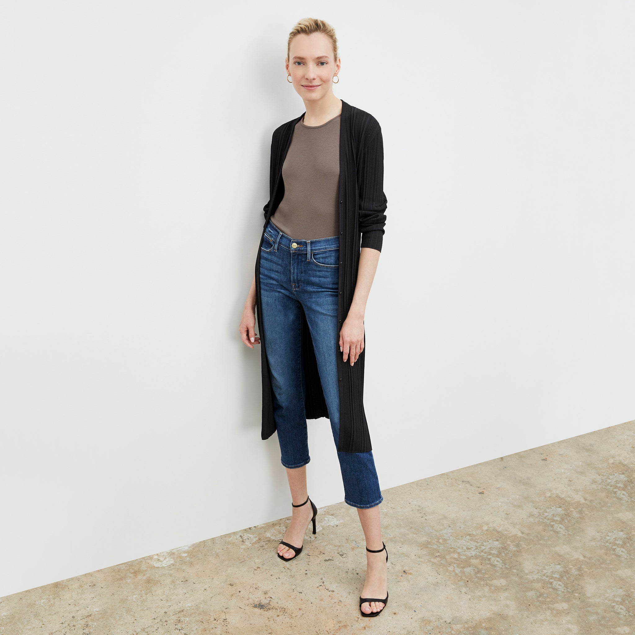 Front image of a woman standing wearing the Paige T-Shirt—Fine Ribbed Cotton in Pebble