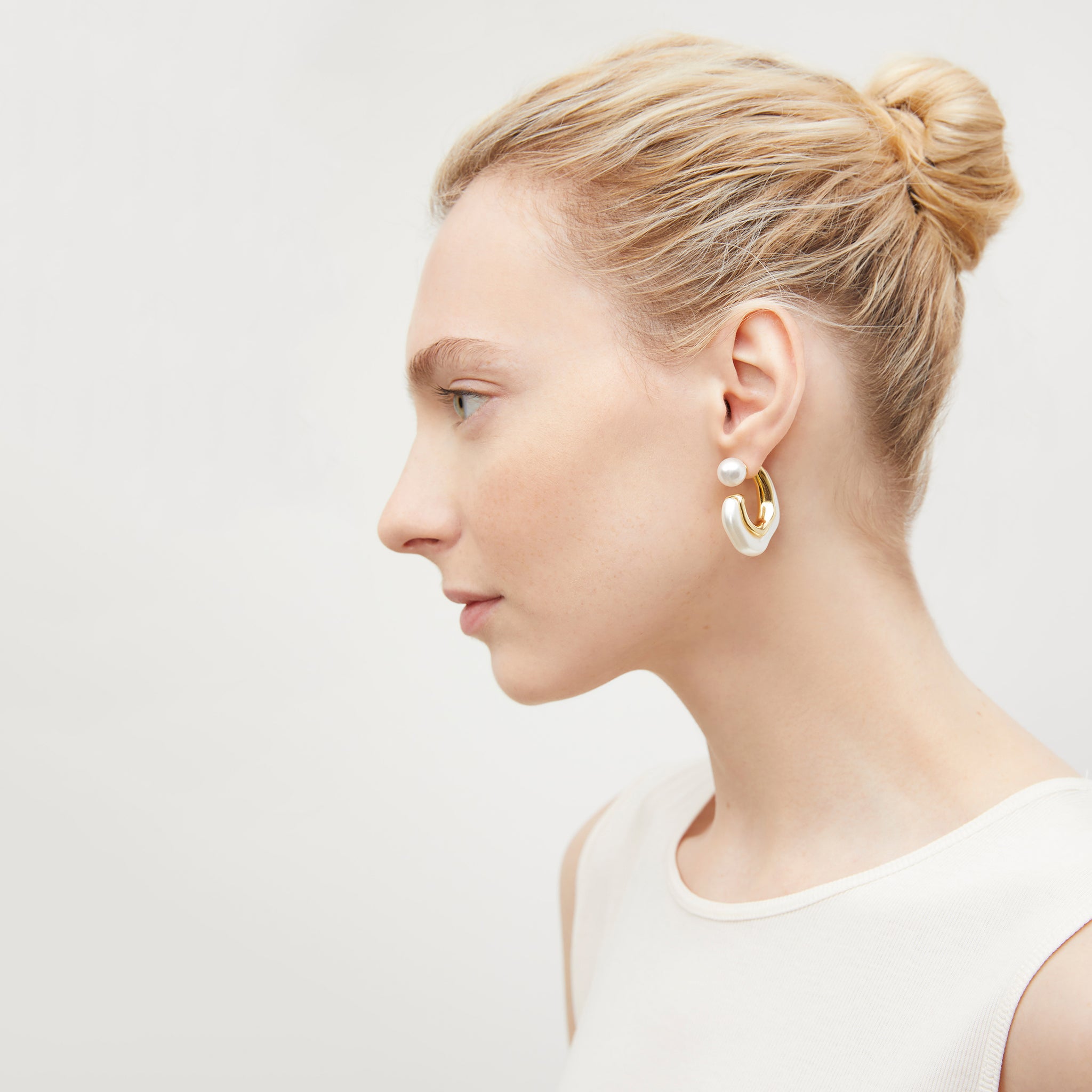 image of a woman wearing the etel earrings