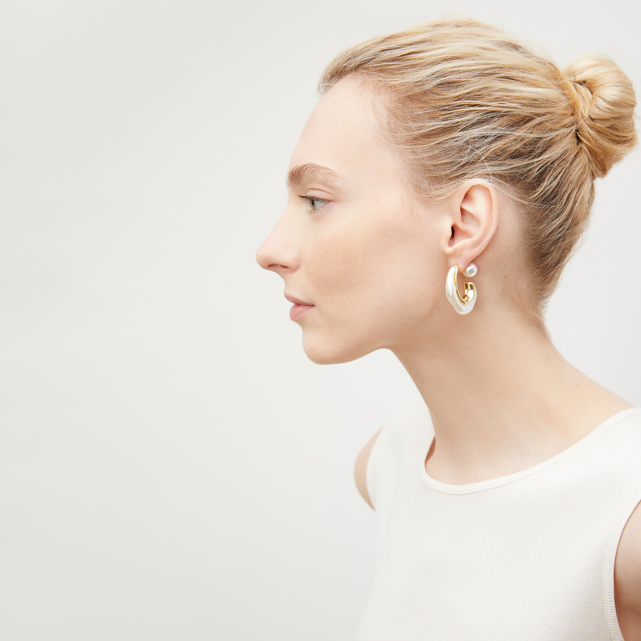 image of a woman wearing the etel earrings