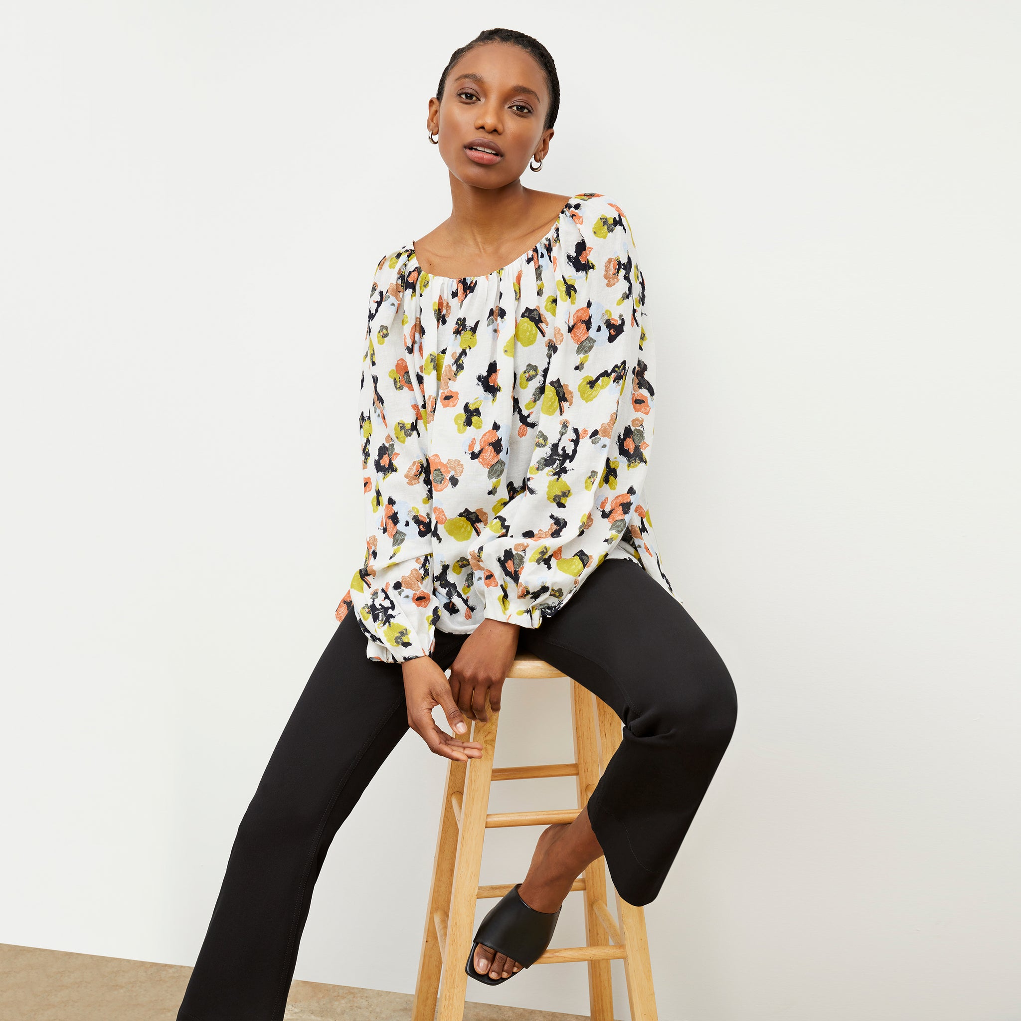 Front image of a woman wearing the Camilla top in meadow print linen