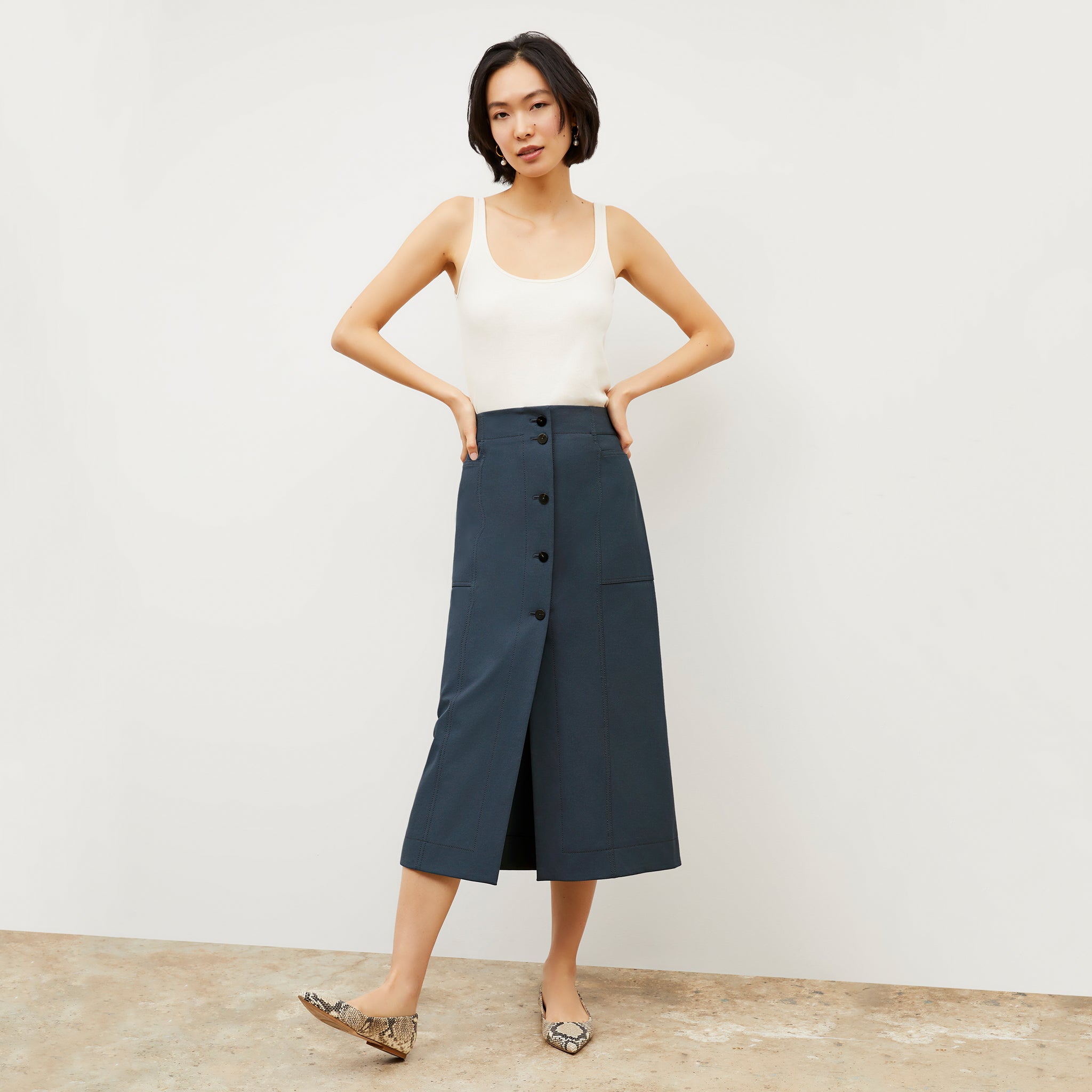 Front image of a woman wearing the Lane skirt in Dusty Indigo