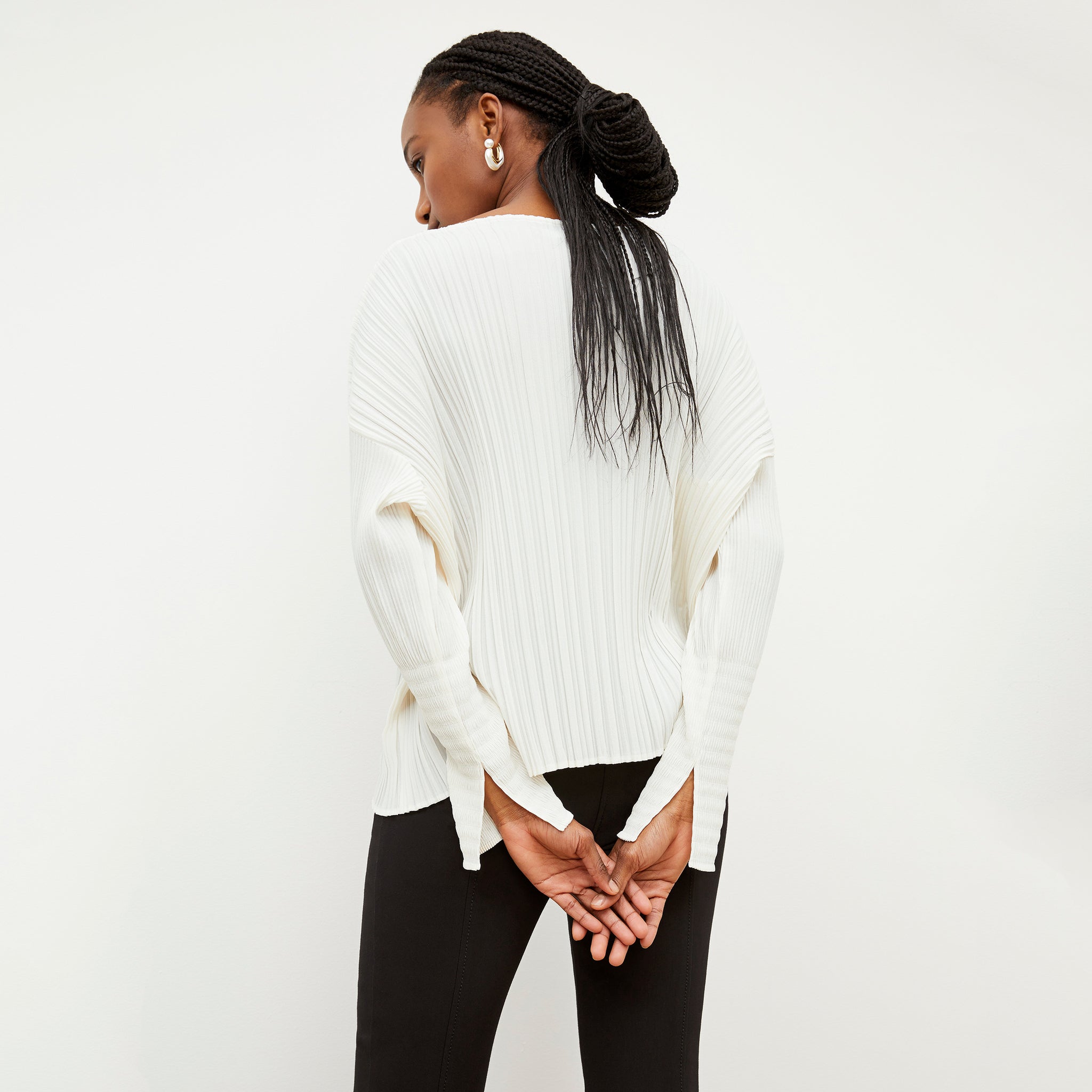 Back image of a woman wearing the Lasha Top - Micro Pleat in Ivory