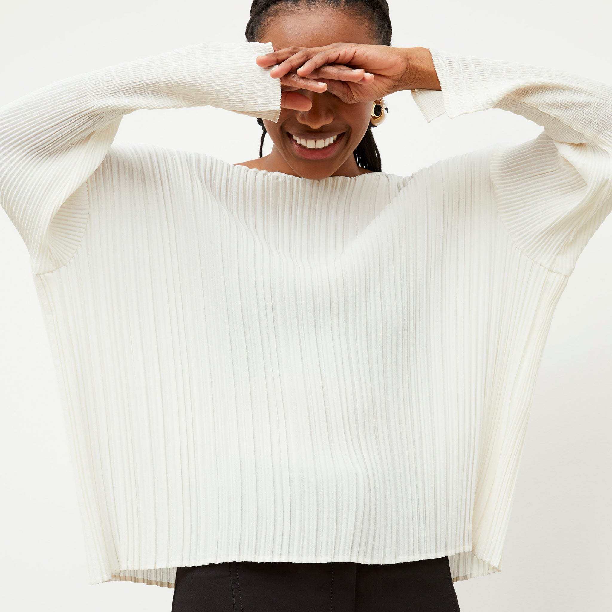 Front image of a woman wearing the Lasha Top - Micro Pleat in Ivory