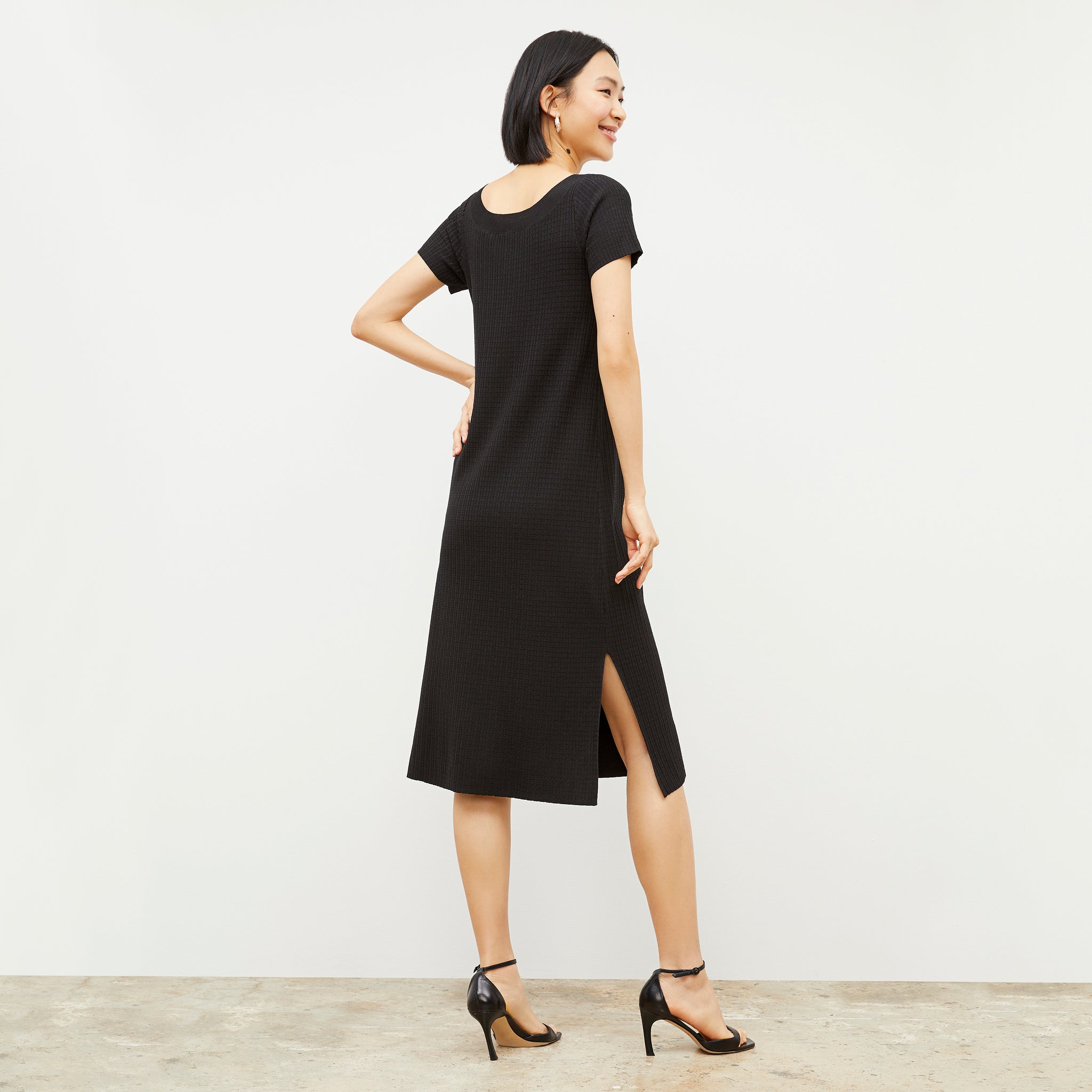 Back image of a woman wearing the Danica Dress - Geo Micro Knit in Black