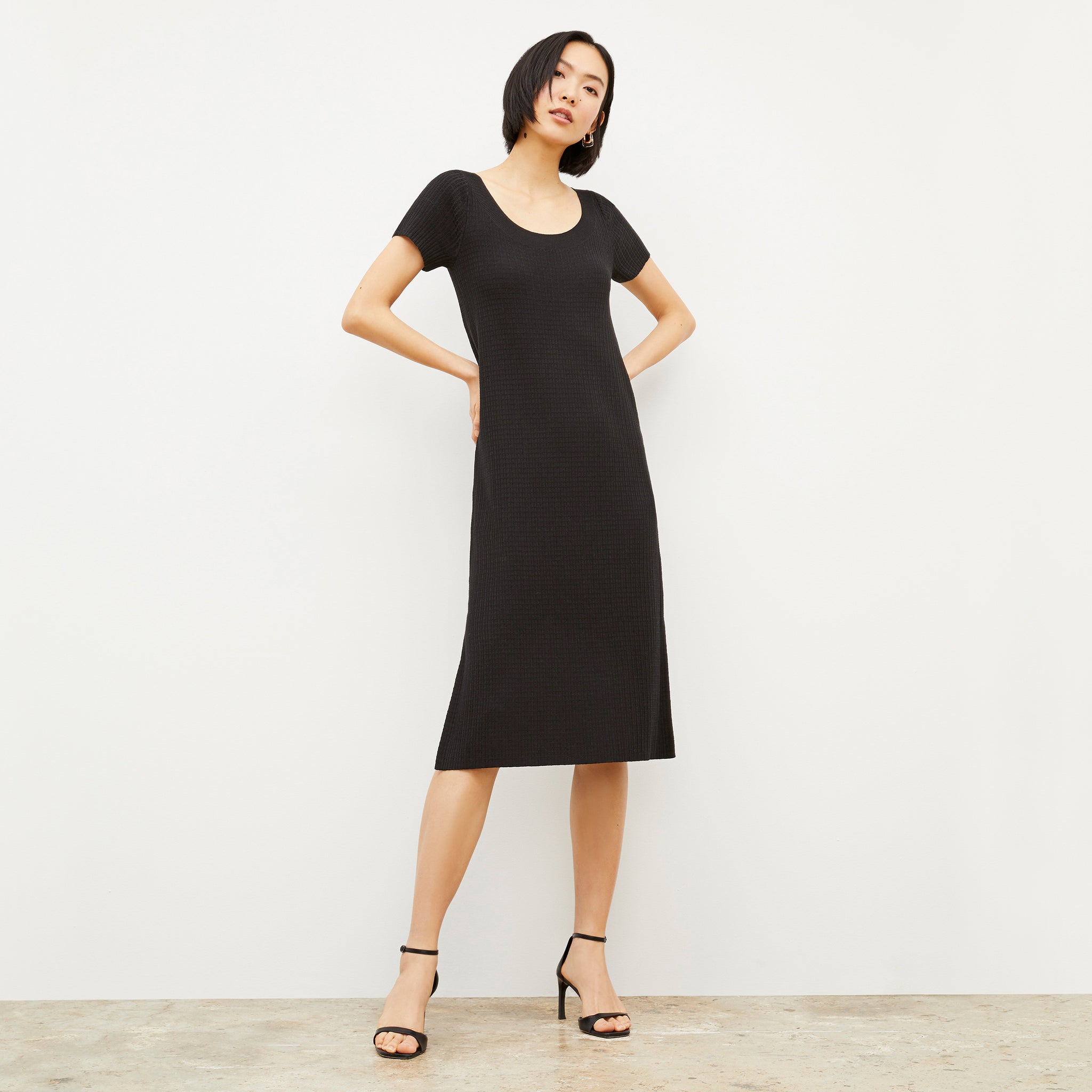 Front image of a woman wearing the Danica Dress - Geo Micro Knit in Black 
