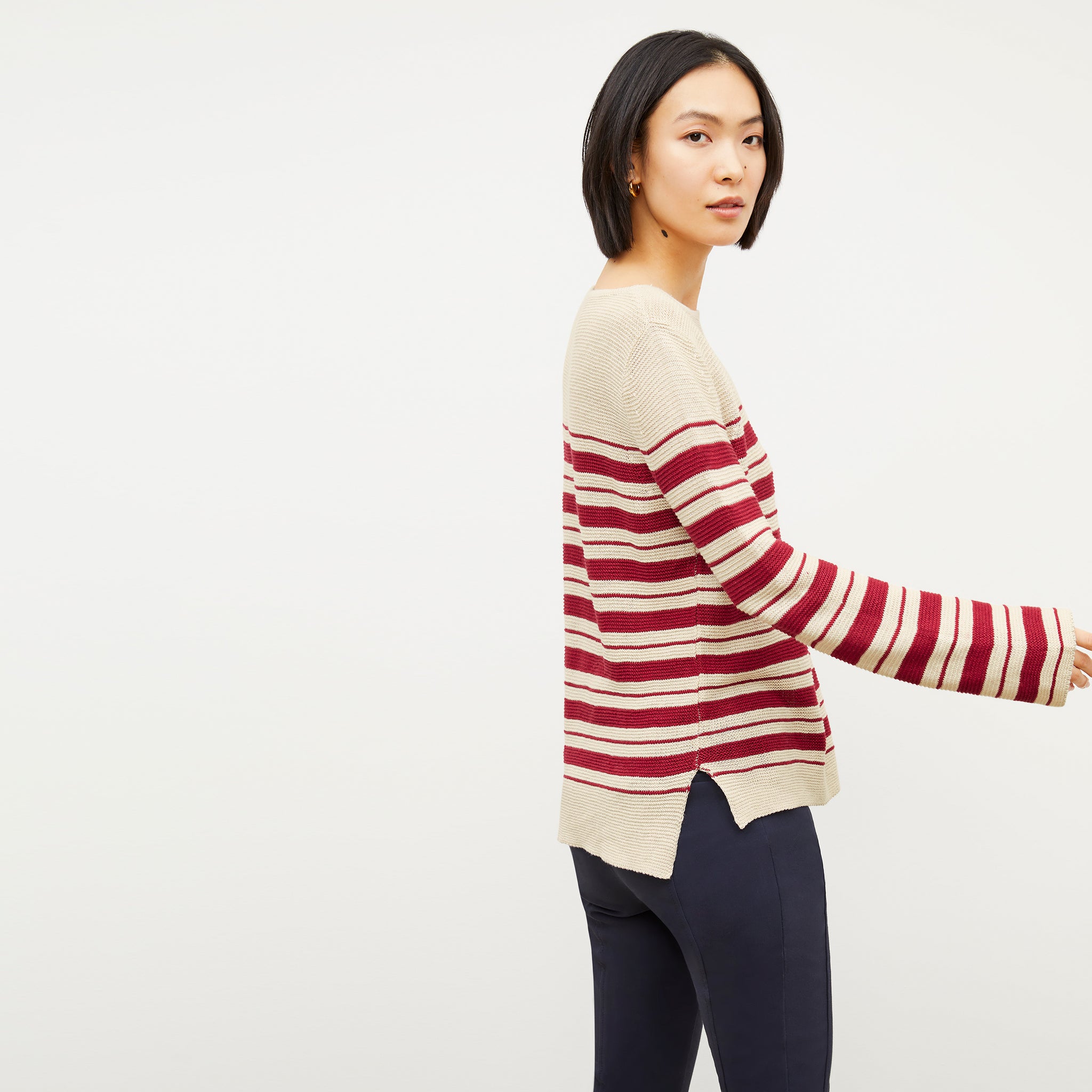 Image of a woman wearing the Samara Sweater in Crimson / Ivory