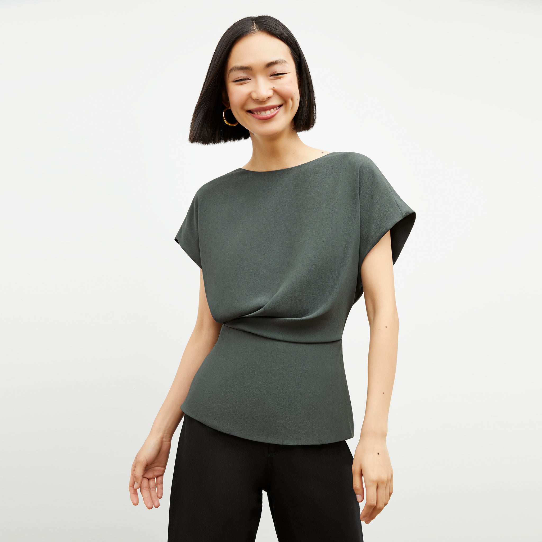 Front image of a woman wearing the Nejvi Top in Aloe 