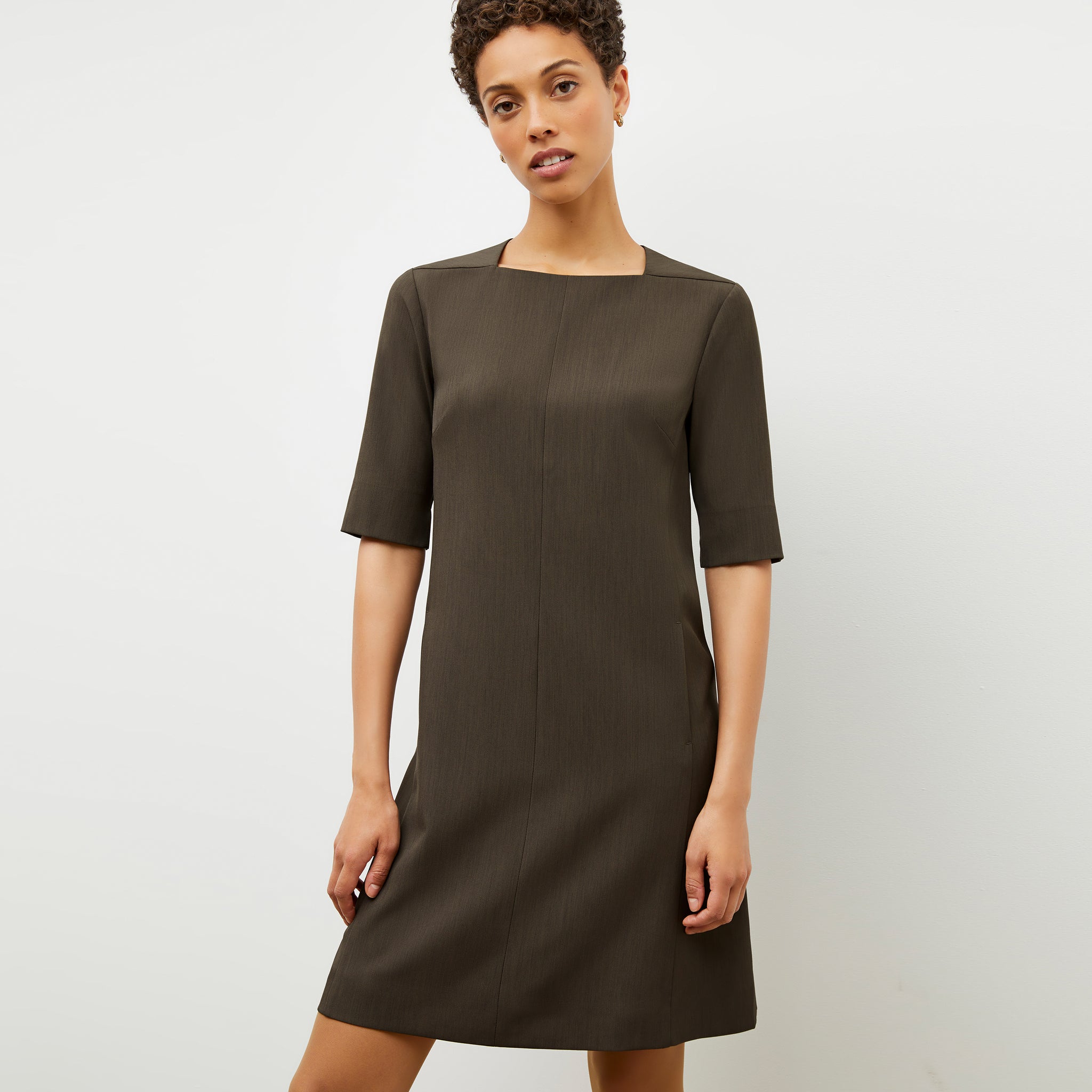 Front image of a woman wearing the emily dress in kale 
